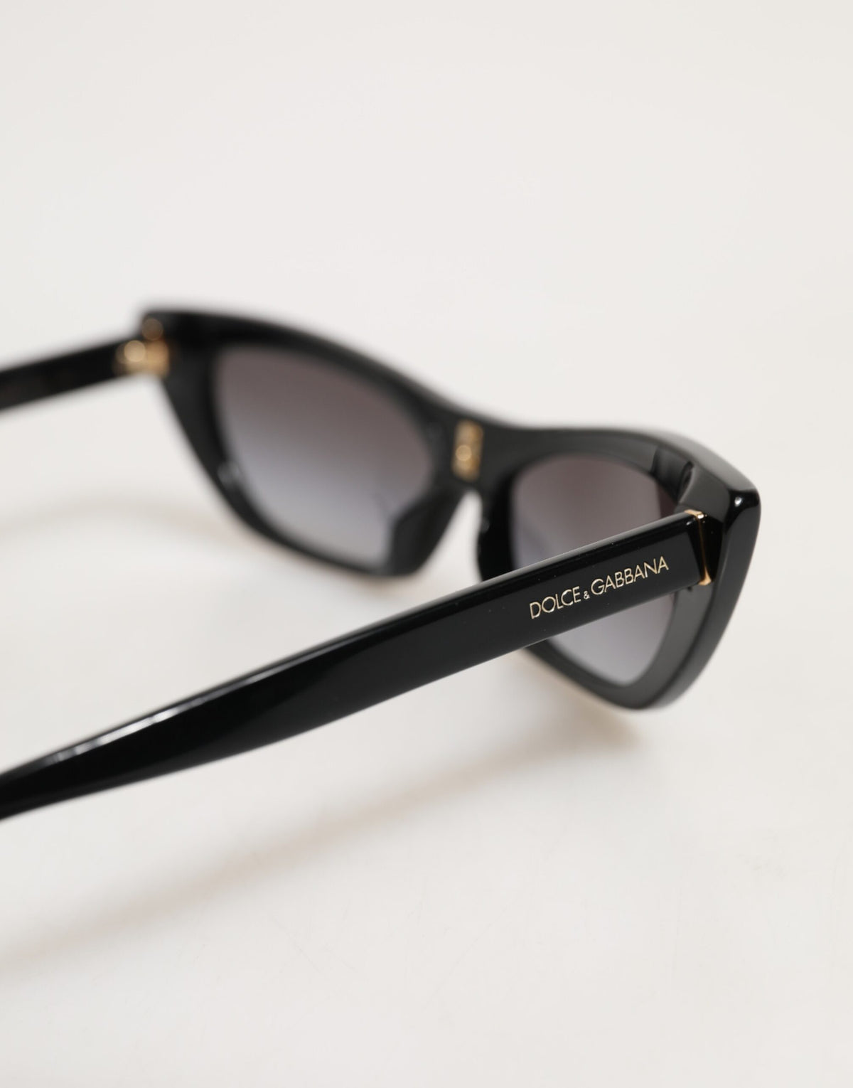 Indulge in the exquisite Dolce & Gabbana Black Re-Edition DNA Cat-Eye Frame Sunglasses, where Italian craftsmanship meets luxurious allure, perfect for the discerning eye.