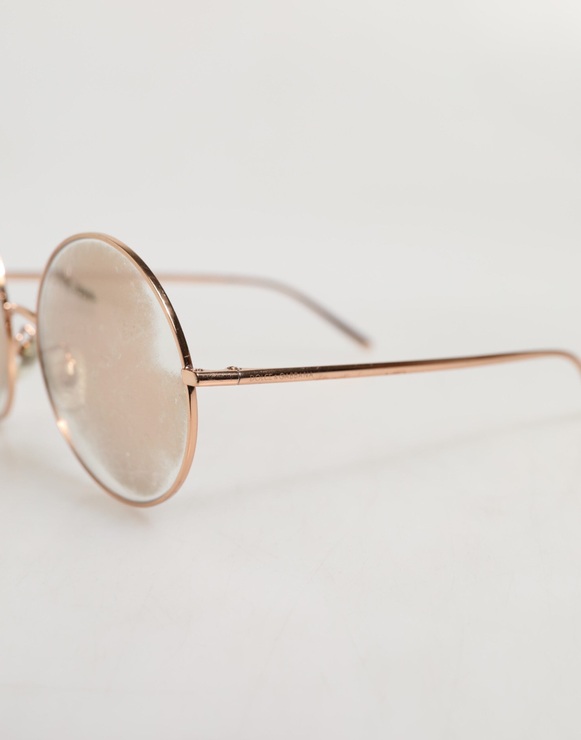 Elevate your style with Dolce & Gabbana's Rose Gold Plated Round Lenses Sunglasses, a testament to Italian craftsmanship and luxury, perfect for the discerning individual.