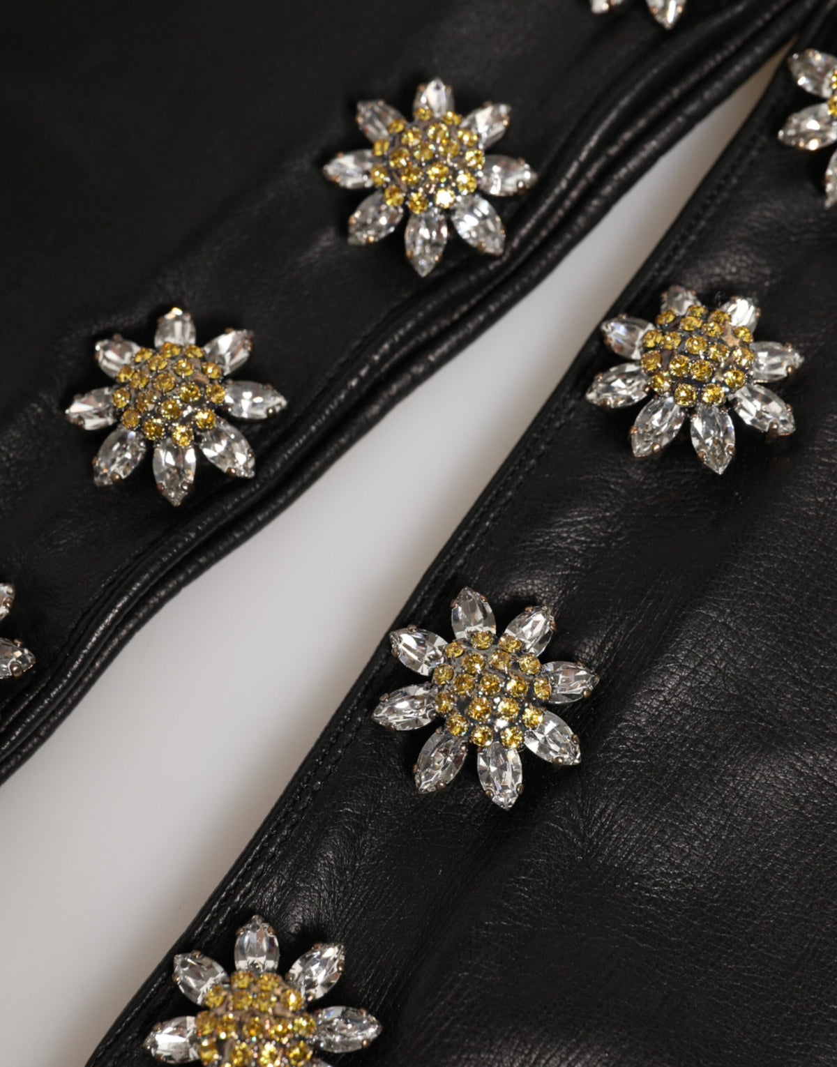 Indulge in the exquisite Dolce & Gabbana Black Leather Embellished Long Mitten Gloves, where premium lamb leather meets exceptional artistry for a timeless fashion statement.