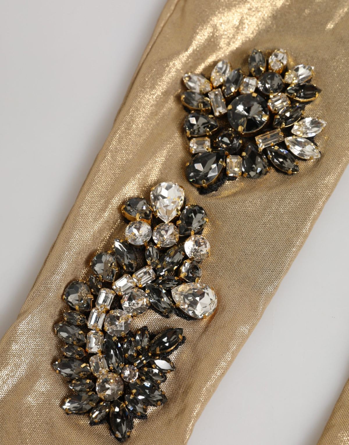Indulge in the exquisite allure of Dolce & Gabbana's Beige Satin Crystal Elbow Length Mitten Gloves, a testament to luxury craftsmanship that elevates evening elegance.