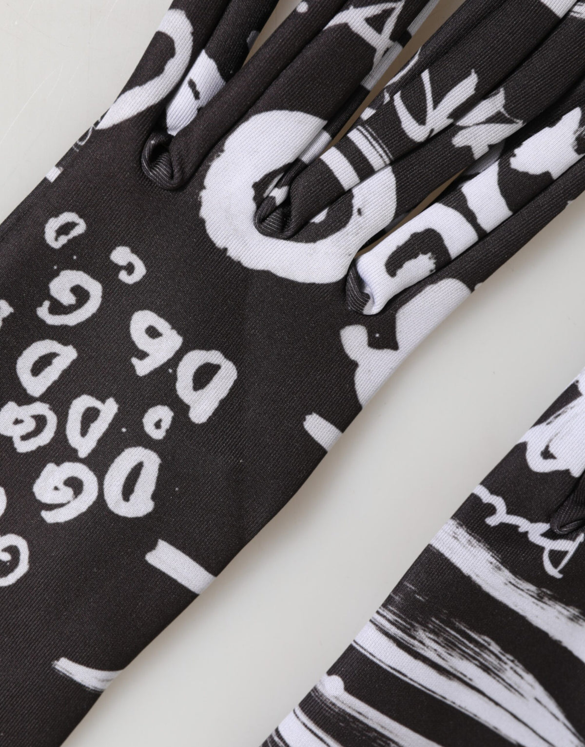 Indulge in the exquisite Dolce & Gabbana Black White DG Logo Elbow Length Mitten Gloves, crafted in Italy from a luxurious blend, embodying timeless elegance and sophistication.