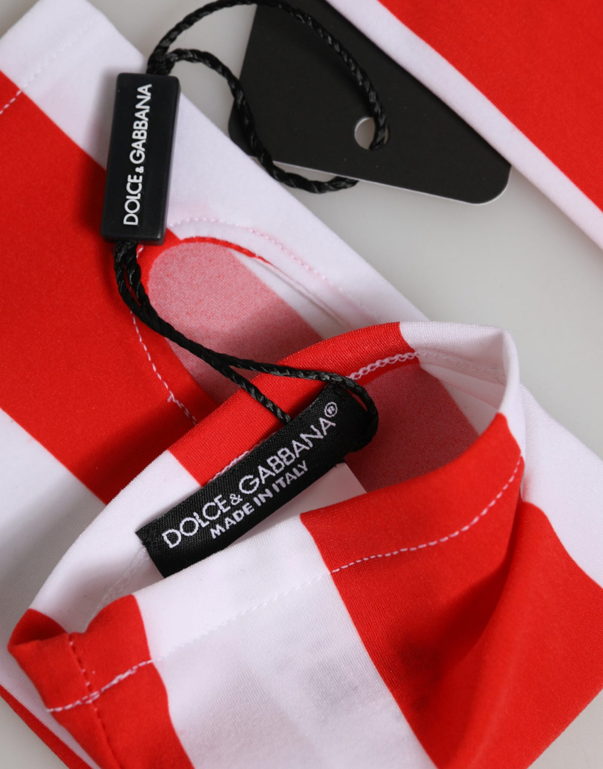 Indulge in the exquisite Dolce & Gabbana Red White Nylon Fingerless Gloves, a luxurious blend of sporty elegance and timeless sophistication, crafted in Italy for the discerning individual.