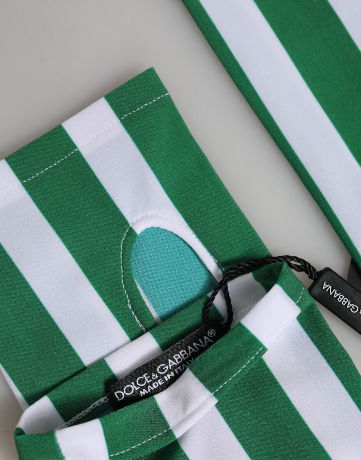 Indulge in the exquisite craftsmanship of Dolce & Gabbana's Green White Nylon Fingerless Gloves, a rare accessory that embodies luxury and contemporary elegance for the discerning individual.