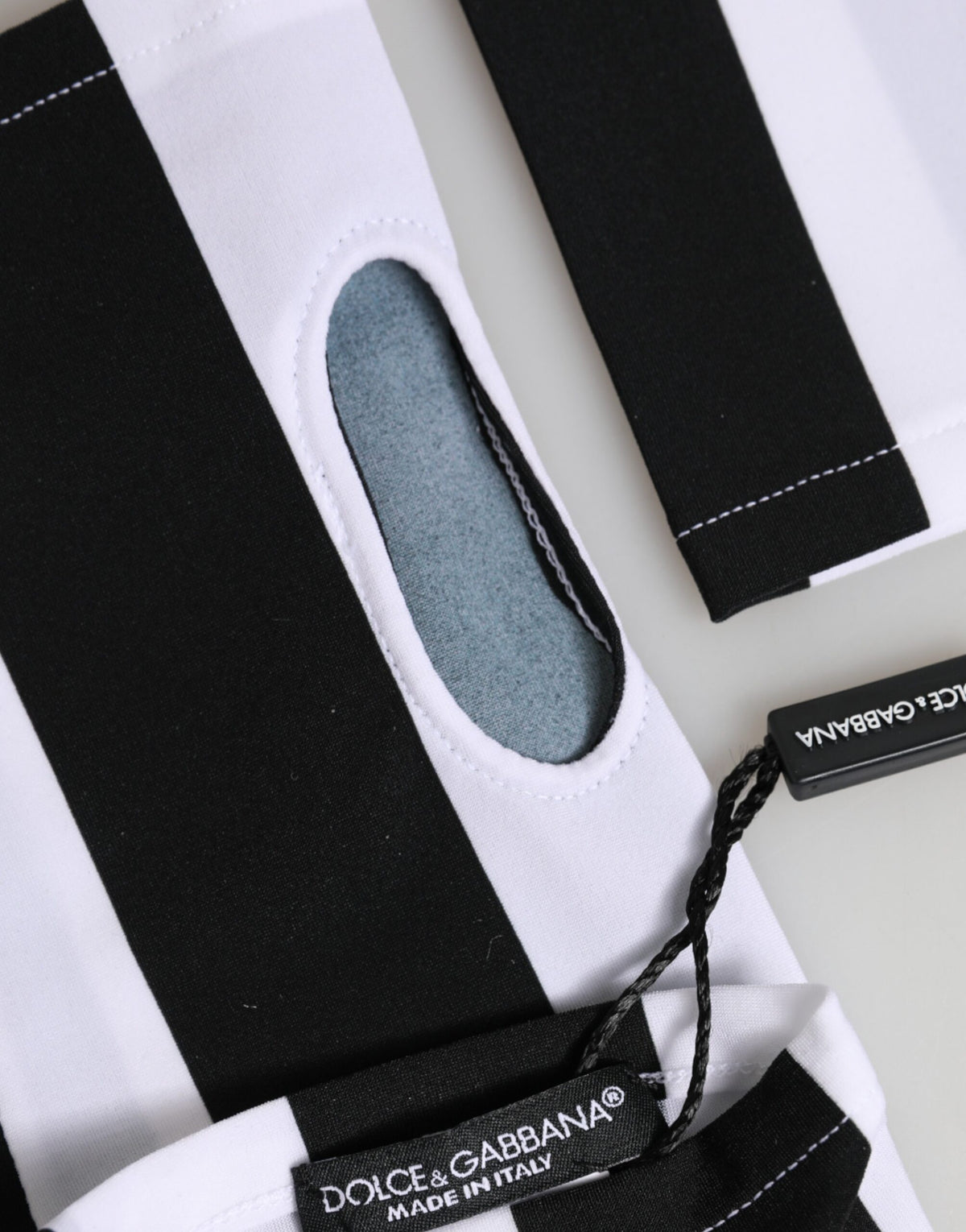 Elevate your style with Dolce & Gabbana's Black White Nylon Fingerless Wrist Length Gloves, a rare blend of sporty elegance and Italian craftsmanship, perfect for discerning tastes.