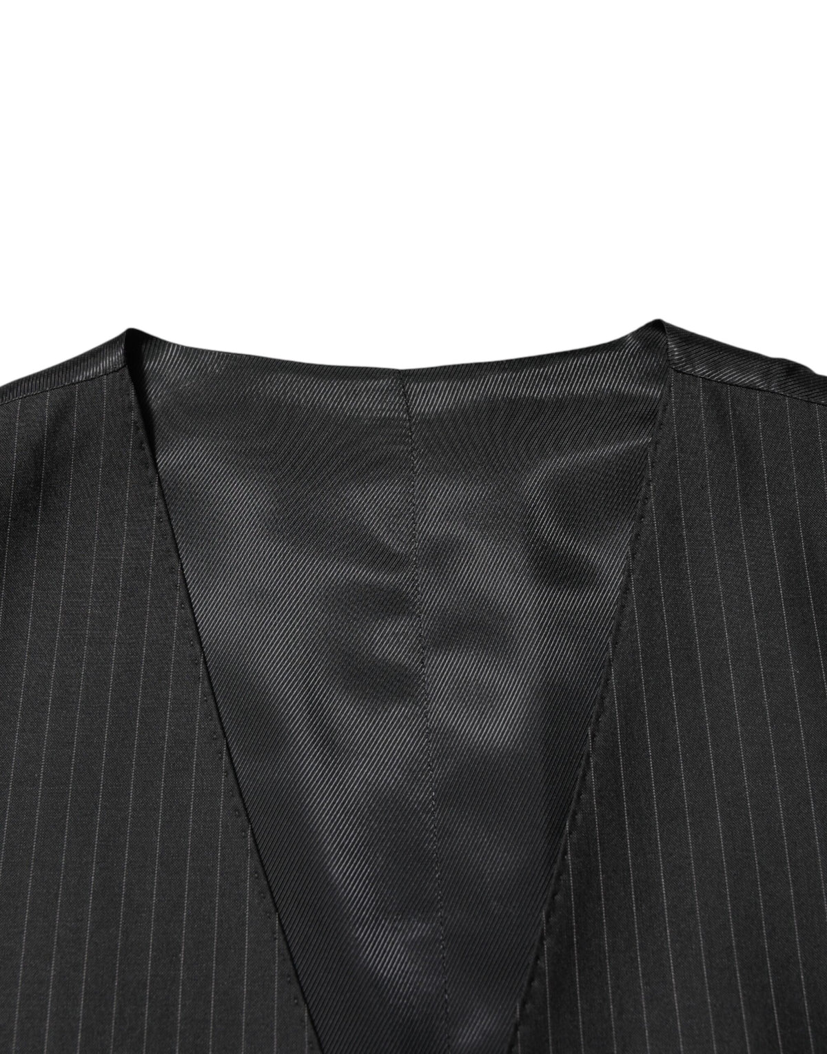 Elevate your wardrobe with the Dolce & Gabbana Black Wool Men Dress Formal Waistcoat Vest, a masterpiece of exquisite craftsmanship and timeless elegance, designed for the discerning individual.