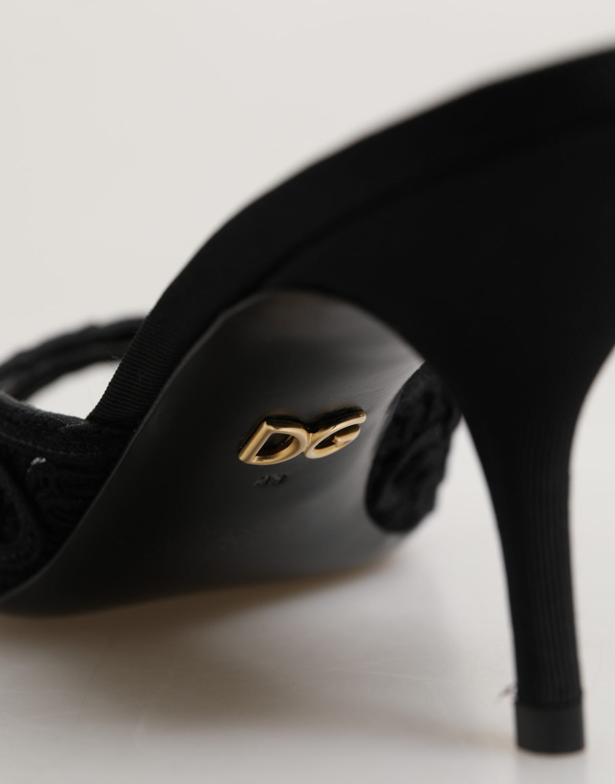 Elevate your elegance with Dolce & Gabbana's Black Embroidered Slip On Heels, crafted in Italy from luxurious materials, perfect for the discerning connoisseur.