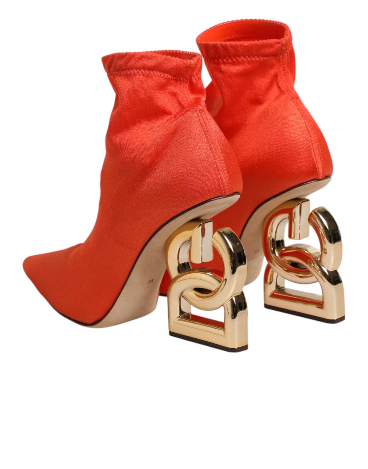 Indulge in the exquisite Dolce & Gabbana Orange DG Logo Heels Ankle Boots, where vibrant leather meets sculptural design, embodying luxury and sophistication for the discerning individual.