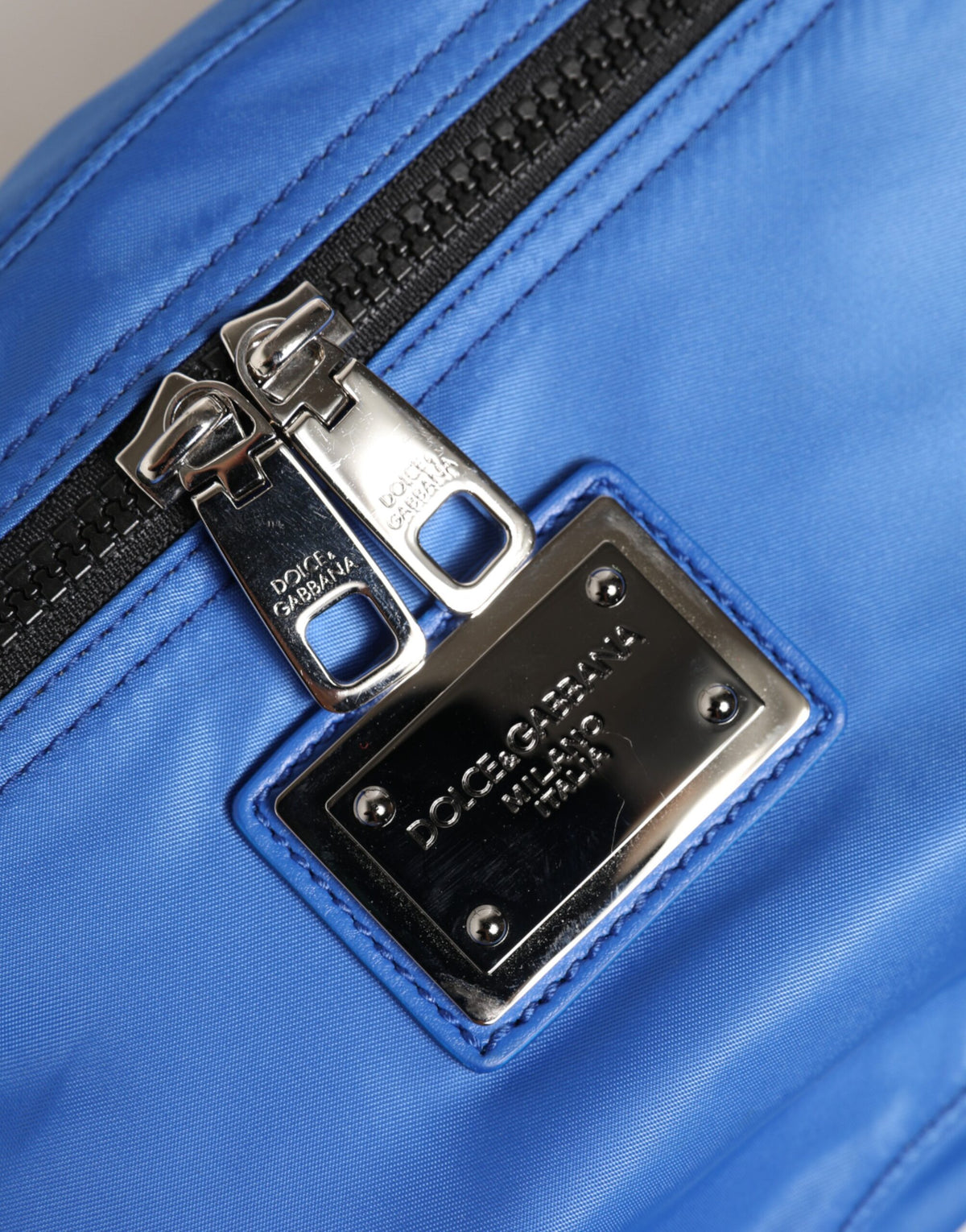 Indulge in the Dolce & Gabbana Blue Logo Plaque Nylon Fanny Pack, where exquisite craftsmanship meets modern luxury, perfect for the discerning individual seeking effortless elegance.