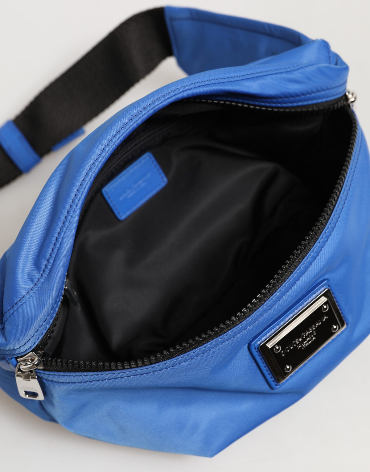 Indulge in the exquisite Dolce & Gabbana Blue Logo Plaque Nylon Fanny Pack, where luxurious craftsmanship meets sophisticated design, perfect for the modern connoisseur.