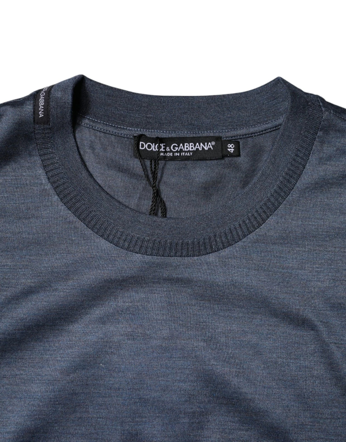 Indulge in the exquisite allure of the Dolce & Gabbana Blue Silk Crew Neck T-shirt, where unparalleled craftsmanship meets timeless elegance, perfect for the discerning individual.