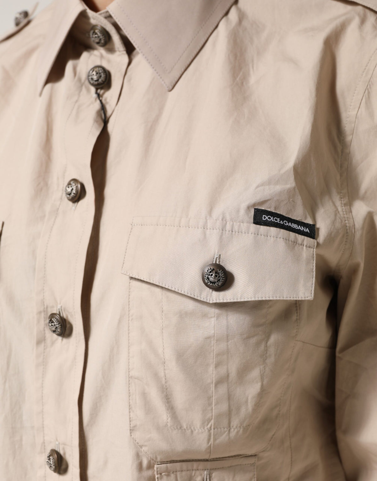 Indulge in the exquisite Dolce & Gabbana beige collared long sleeve cotton shirt top, a timeless piece reflecting Italian craftsmanship and sophisticated allure.