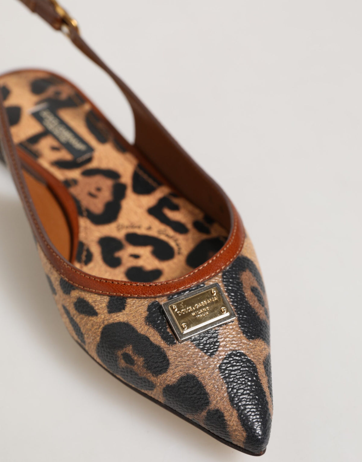 Experience the exquisite allure of Dolce & Gabbana's Brown Leopard Slingback Flats, where unparalleled craftsmanship meets luxurious comfort for the discerning individual.