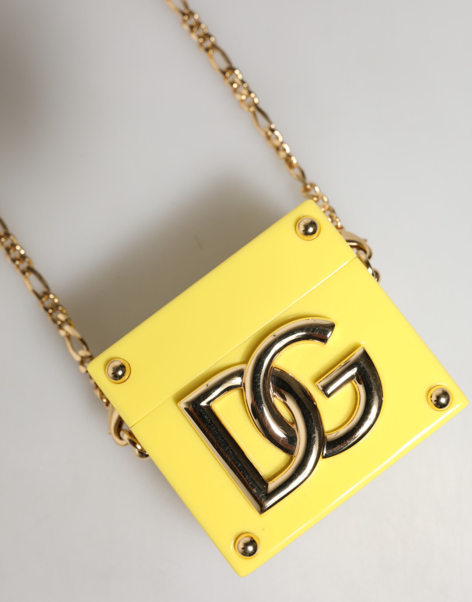 Elevate your accessory game with the Dolce & Gabbana Yellow DG Logo Plaque AirPods Case, a luxurious blend of craftsmanship and chic design, perfect for the discerning individual.
