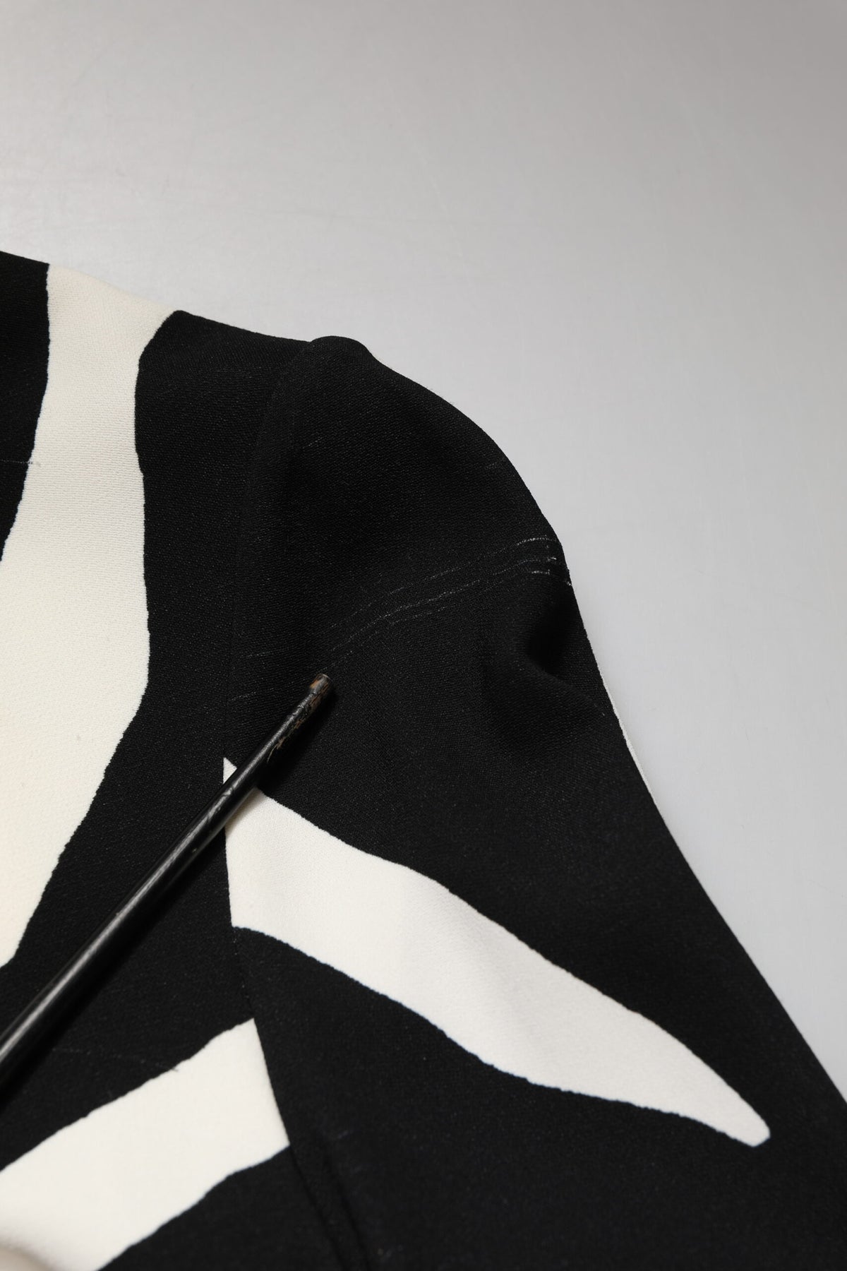 Experience the allure of the Dolce & Gabbana Black White Zebra Viscose Sheath Midi Dress, a masterpiece of haute couture that embodies exquisite craftsmanship and timeless elegance.