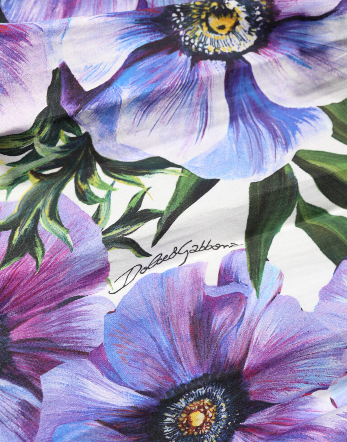 Elevate your wardrobe with the Dolce & Gabbana Purple Anemone Print Pleated Midi Dress, a masterpiece of Italian craftsmanship in luxurious cotton, perfect for the discerning connoisseur.