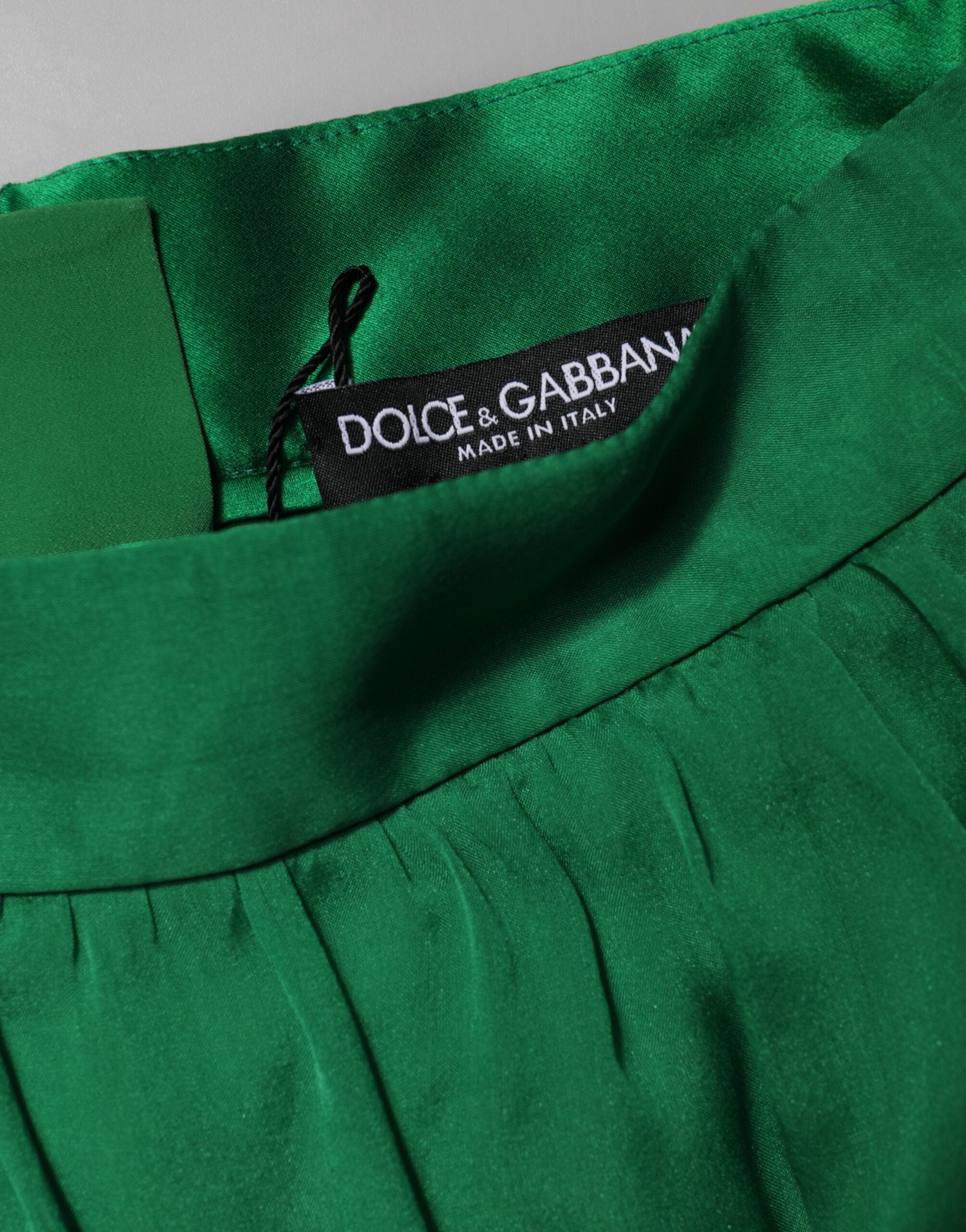 Indulge in the exquisite allure of Dolce & Gabbana's Green Silk High Waist Hot Pants, a luxurious testament to Italian craftsmanship that elevates your style with timeless elegance.