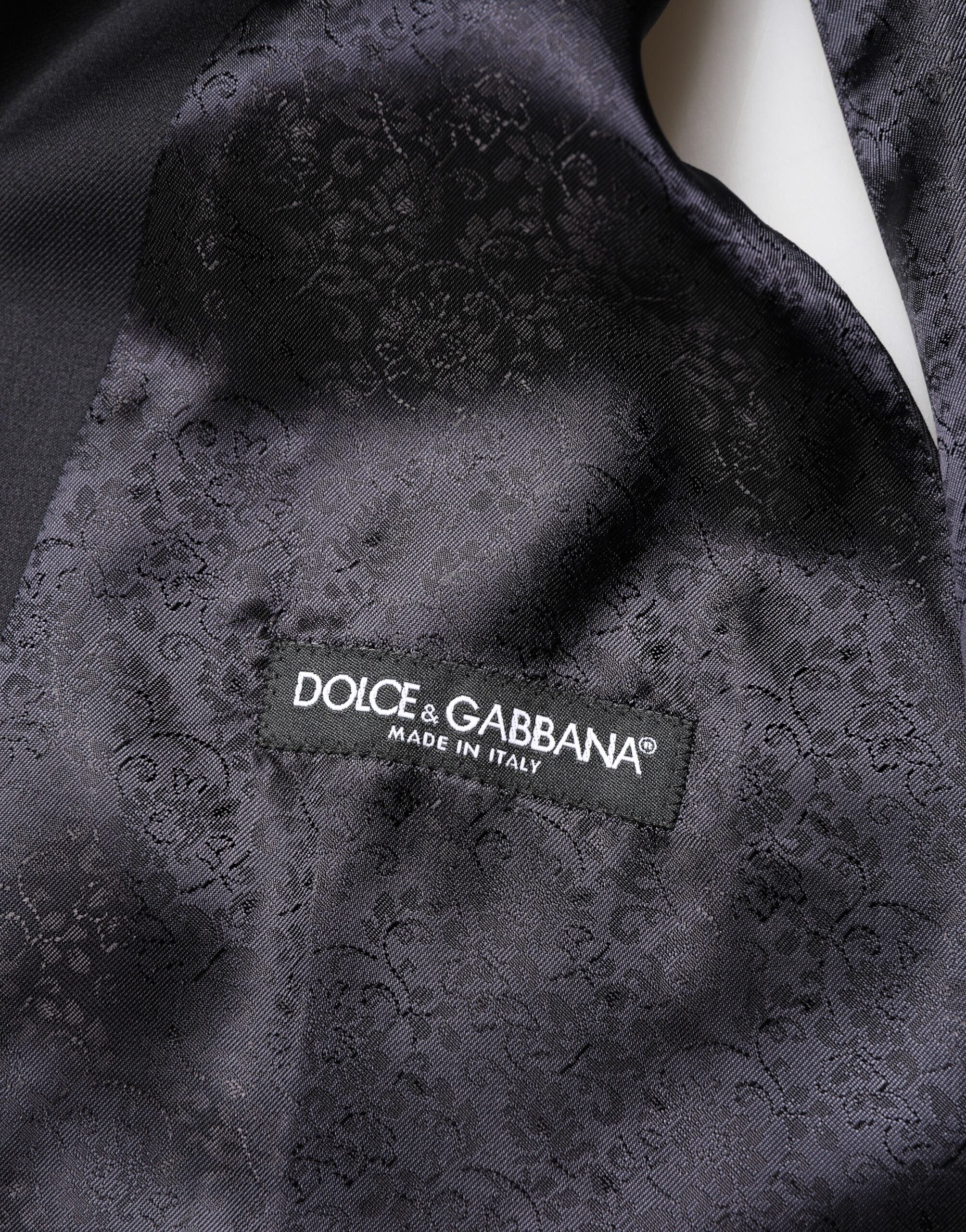 Elevate your elegance with the Dolce & Gabbana Black Wool Single Breasted 3 Piece Suit, a masterclass in Italian craftsmanship and luxurious materials, designed for the discerning individual.