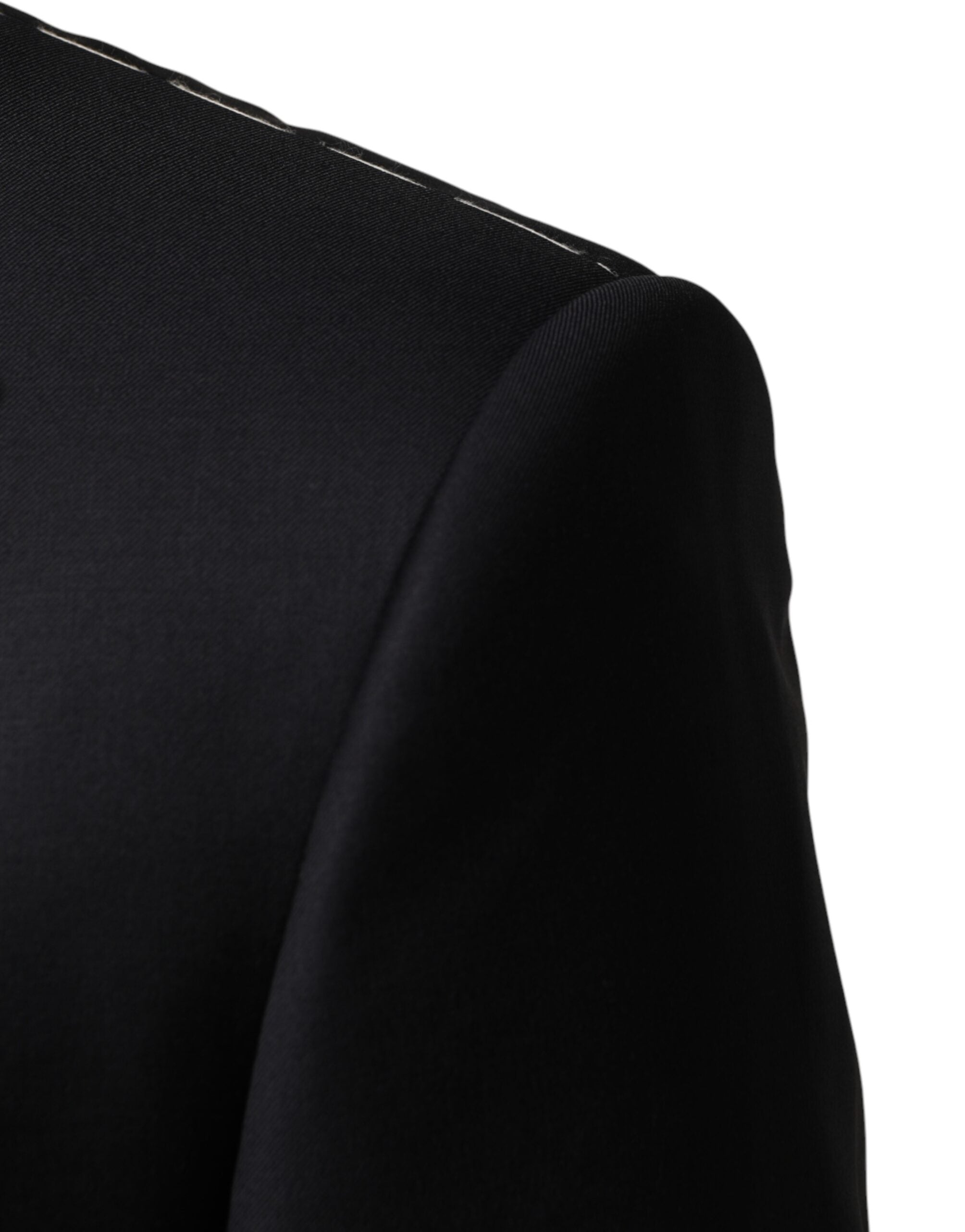 Discover the exquisite Dolce & Gabbana Black Wool Single Breasted 3 Piece Suit, a masterpiece of Italian craftsmanship, blending luxurious materials for the discerning individual.