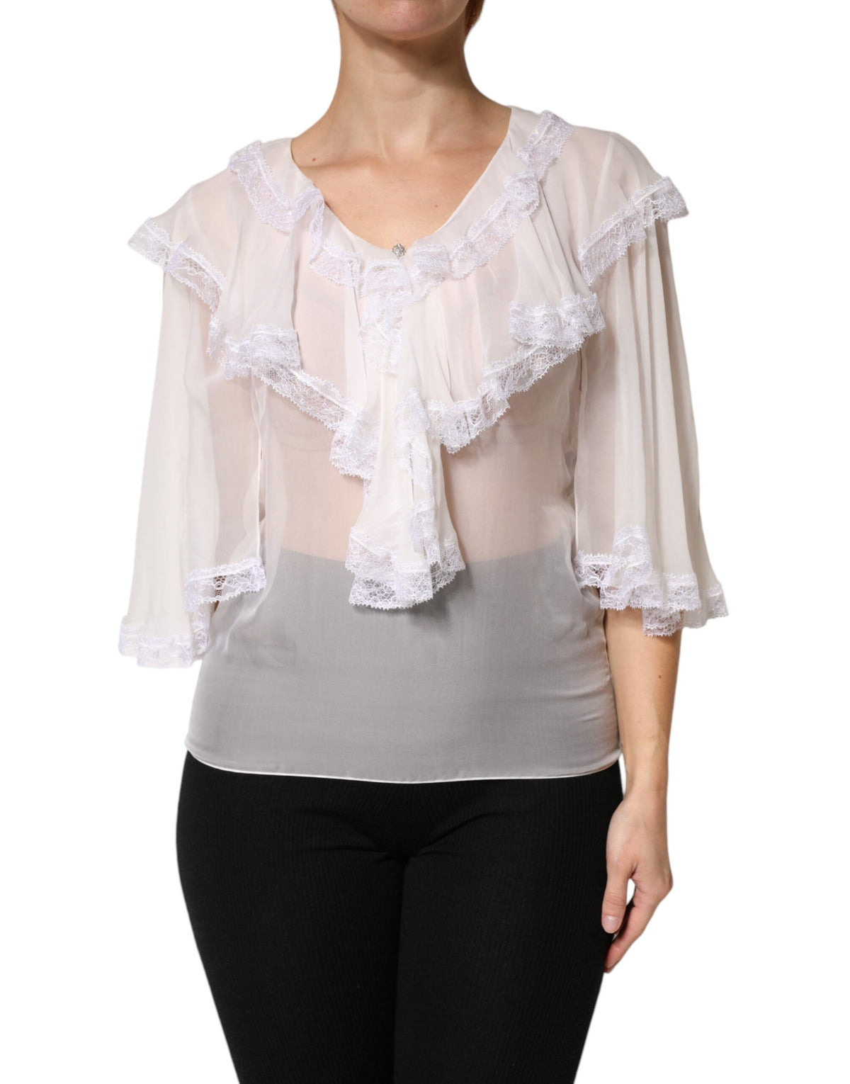 Elevate your wardrobe with the Dolce & Gabbana White Ruffles Lace Long Sleeve Blouse, a silk masterpiece that embodies timeless elegance and exquisite craftsmanship.