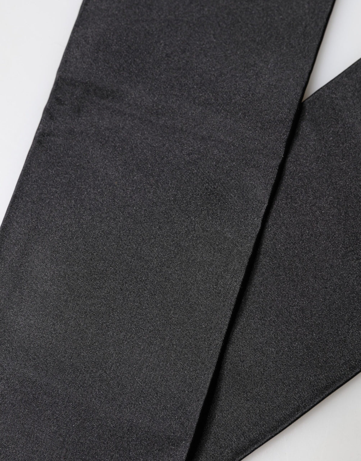 Experience the allure of Dolce & Gabbana's Black Silk Fringes Neck Wrap, a masterpiece of Italian craftsmanship that elevates your style with timeless luxury and artistic flair.