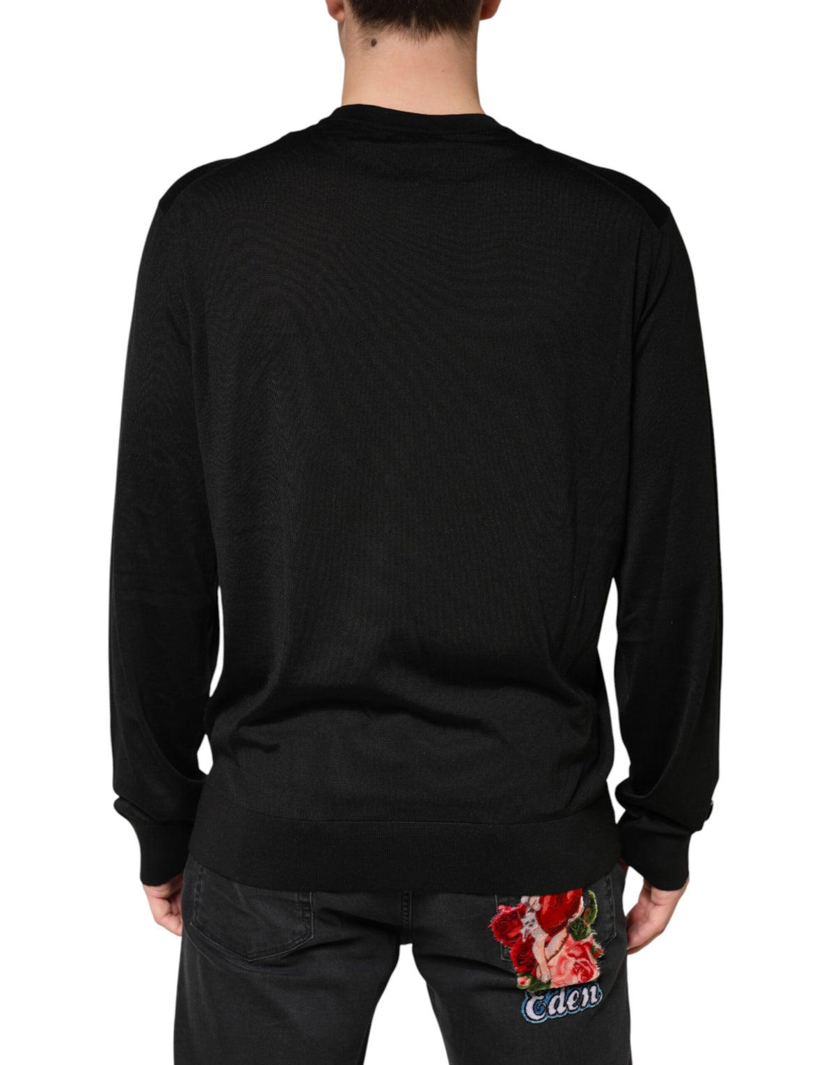 Indulge in the exquisite Dolce & Gabbana Black Silk Men Crew Neck Pullover Sweater, a masterpiece of Italian craftsmanship that embodies luxury and timeless elegance.