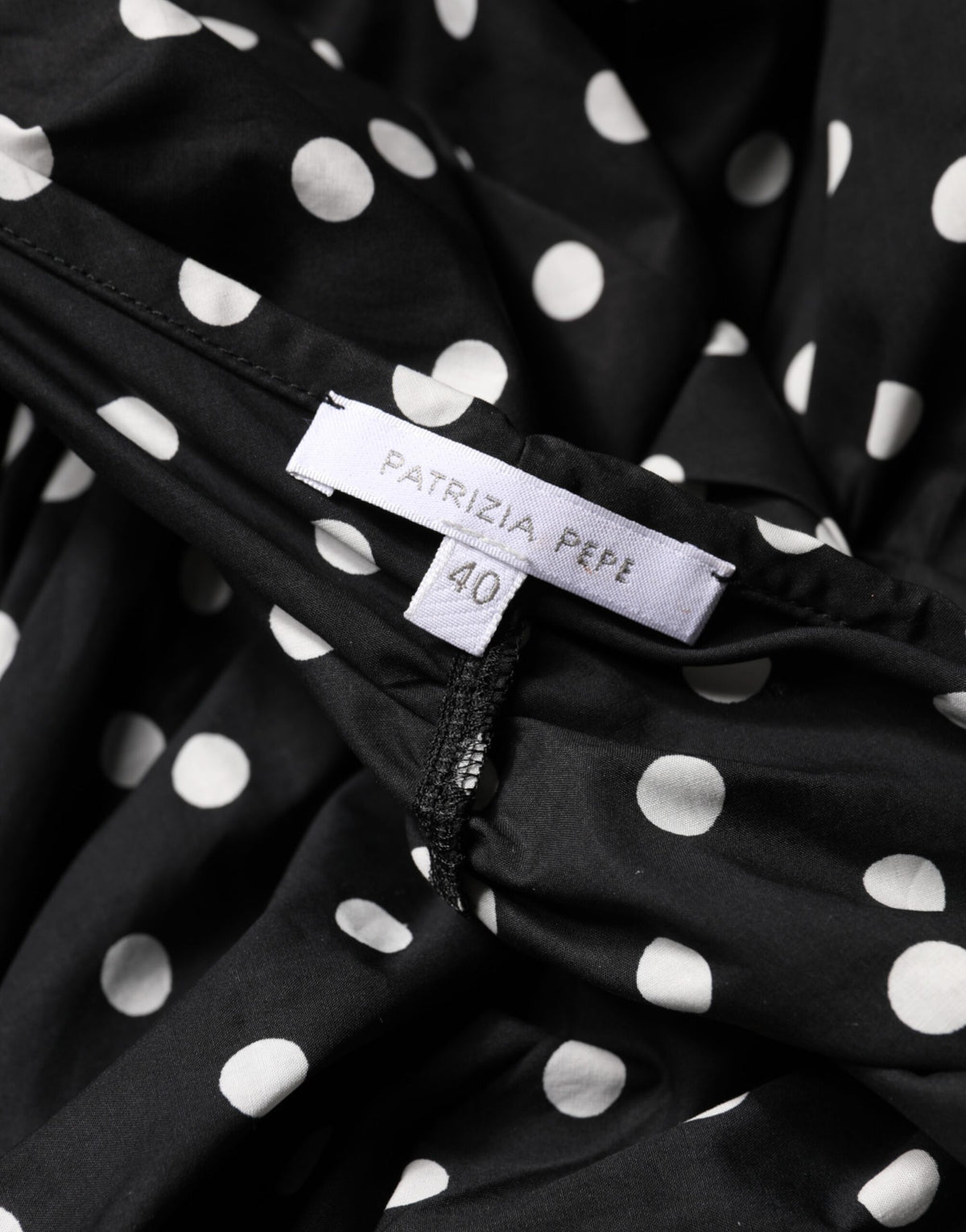 Elevate your wardrobe with the Patrizia Pepe black and white polka dot mini dress, a timeless blend of elegance and sensuality, crafted from luxurious cotton for effortless sophistication.