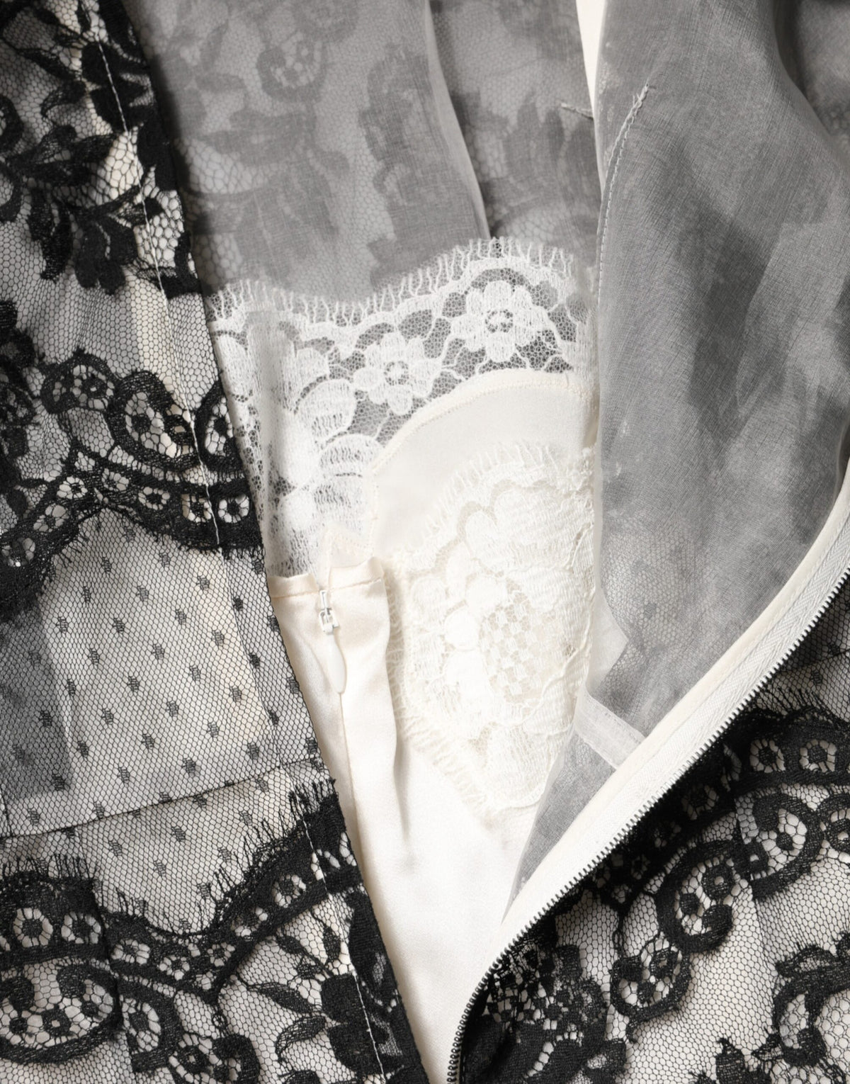 Discover the Dolce & Gabbana Black White Lace Silk Blend MaxiSheath Dress, a timeless masterpiece of Italian craftsmanship that embodies elegance and allure for any formal occasion.