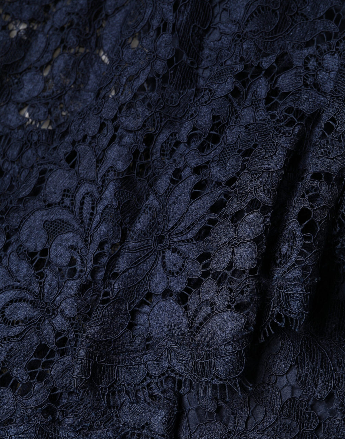 Discover the exquisite Dolce & Gabbana Blue Lace Ruffle A-line Knee Length Dress, a masterpiece of artisanal elegance crafted from luxurious materials, perfect for those who embody sophistication and allure.