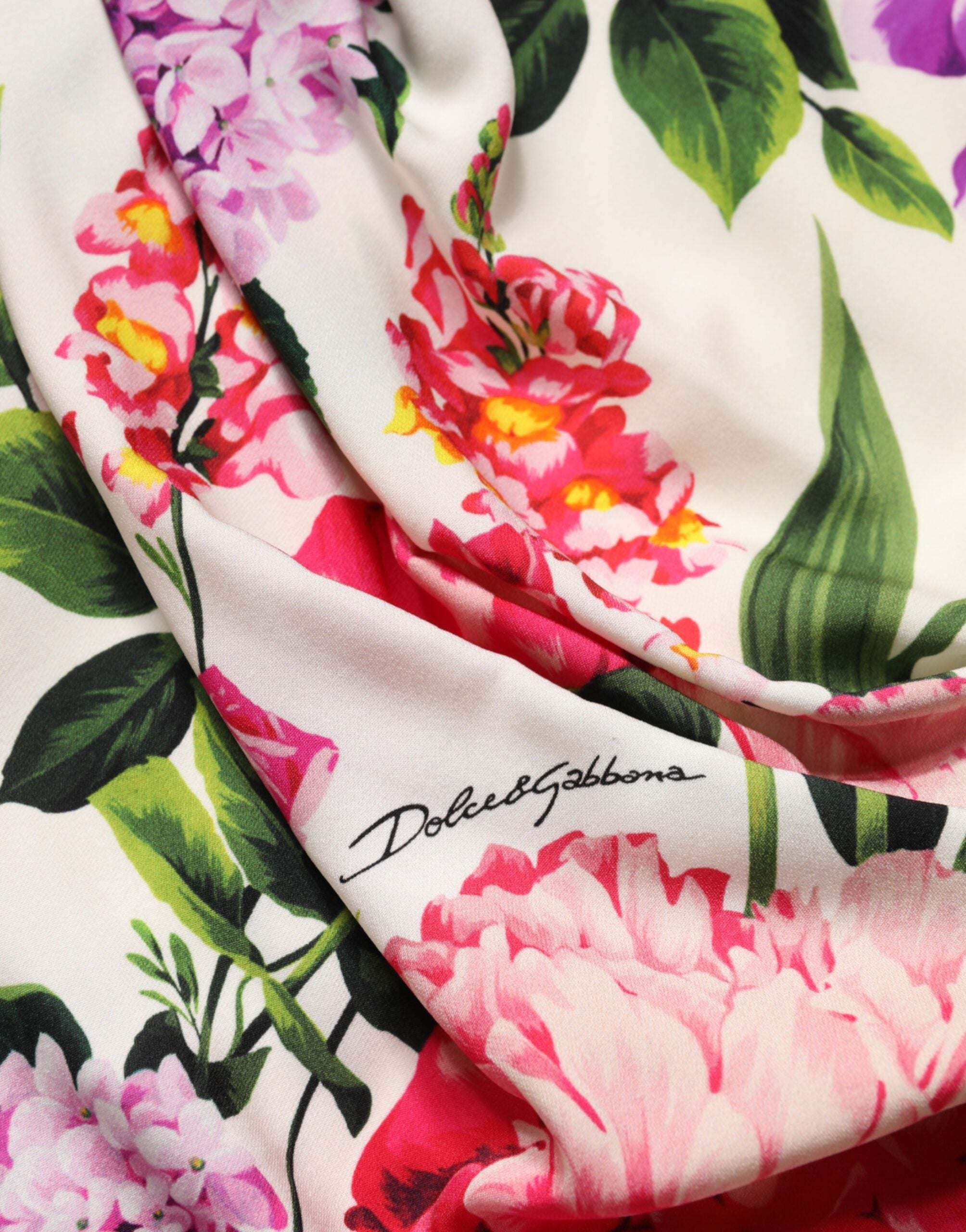 Indulge in the exquisite allure of the Dolce & Gabbana Multicolor Floral Ruched Silk Charmeuse Mini Dress, a masterpiece of Italian craftsmanship that elevates your elegance and ignites desire.