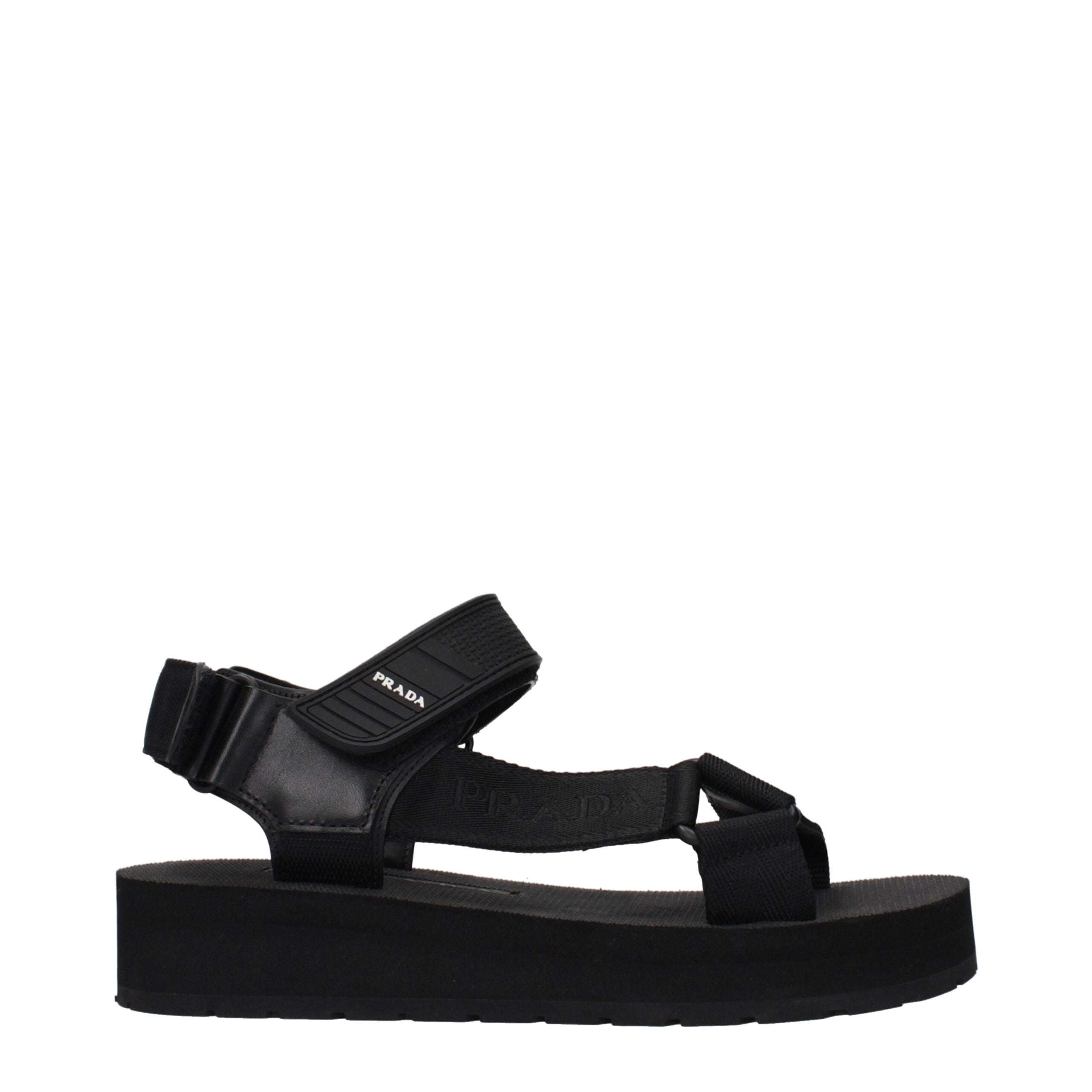 Step into refined elegance with Prada Black Fabric Flat Sandals, where exquisite craftsmanship meets luxurious design for the discerning individual seeking timeless sophistication.