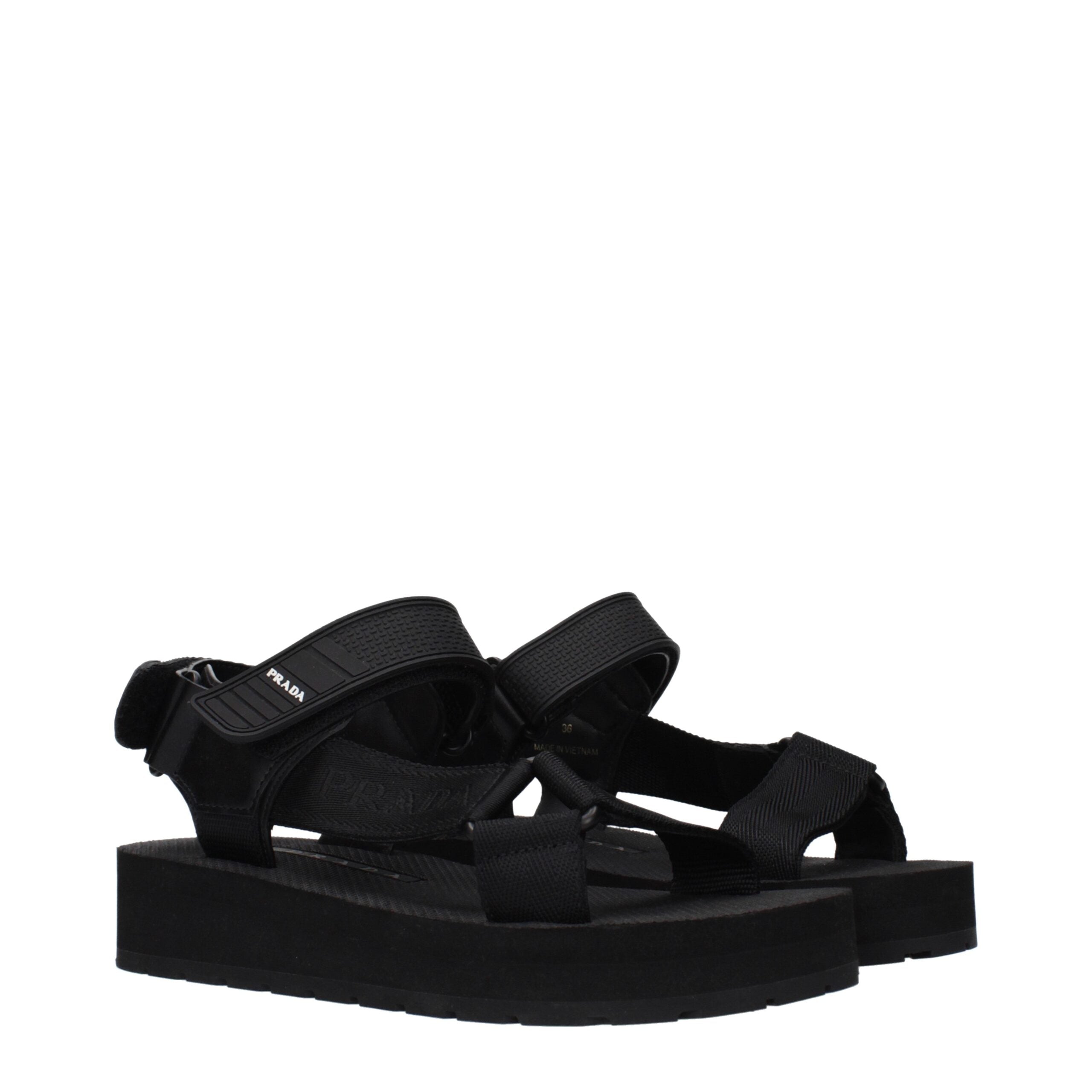 Step into refined elegance with Prada Black Fabric Flat Sandals, where exquisite craftsmanship meets luxurious design, perfect for the discerning individual.