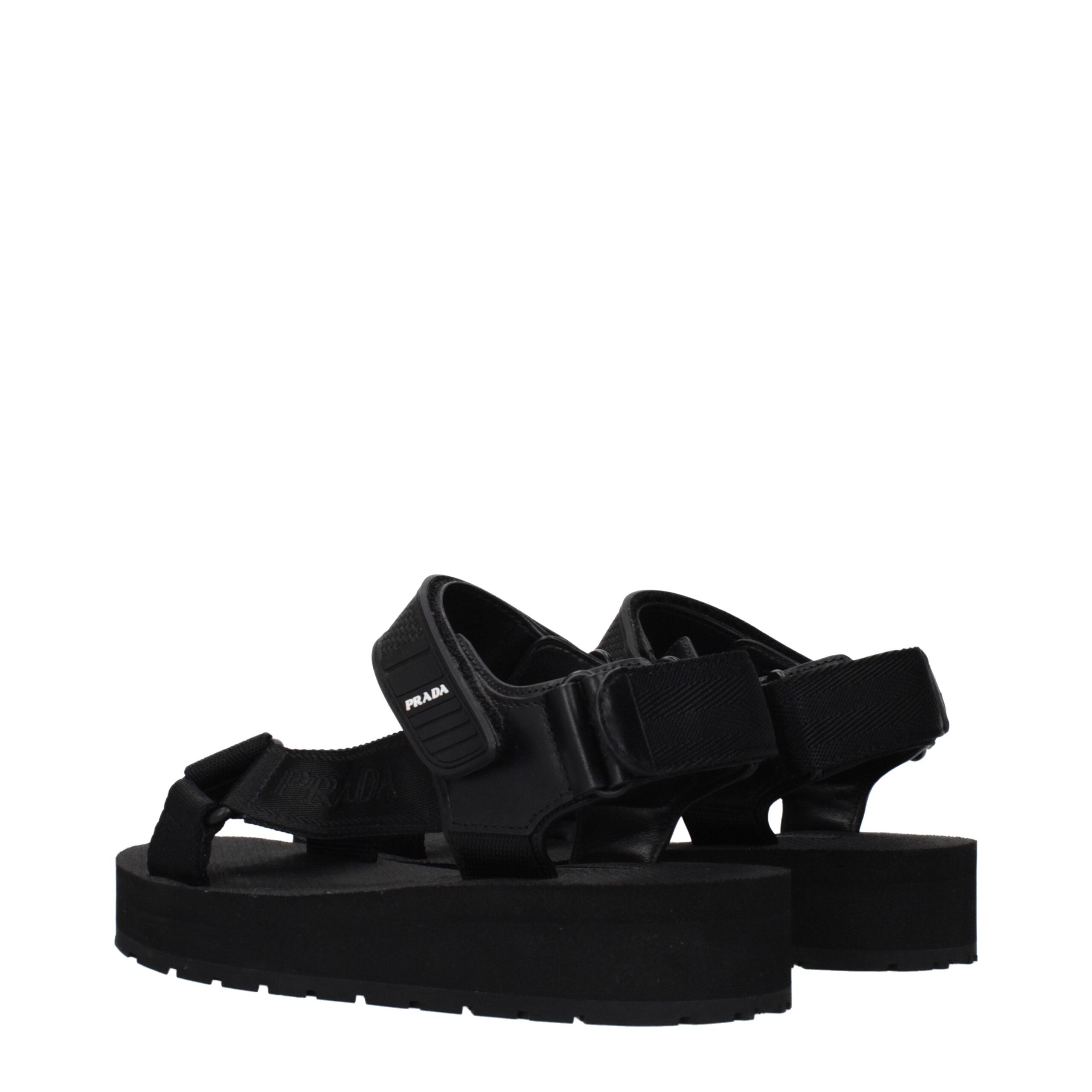 Experience the allure of Prada Black Fabric Flat Sandals, where exquisite craftsmanship meets timeless elegance, perfect for the discerning individual seeking refined luxury.