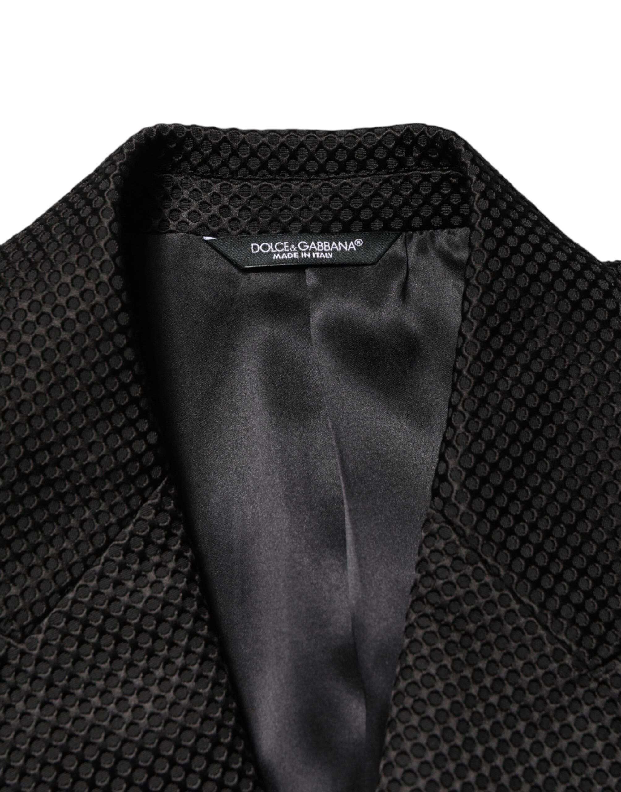 Indulge in the exquisite Dolce & Gabbana Black Cotton Double Breasted Blazer, a masterpiece of Italian craftsmanship that embodies timeless elegance and sophistication.