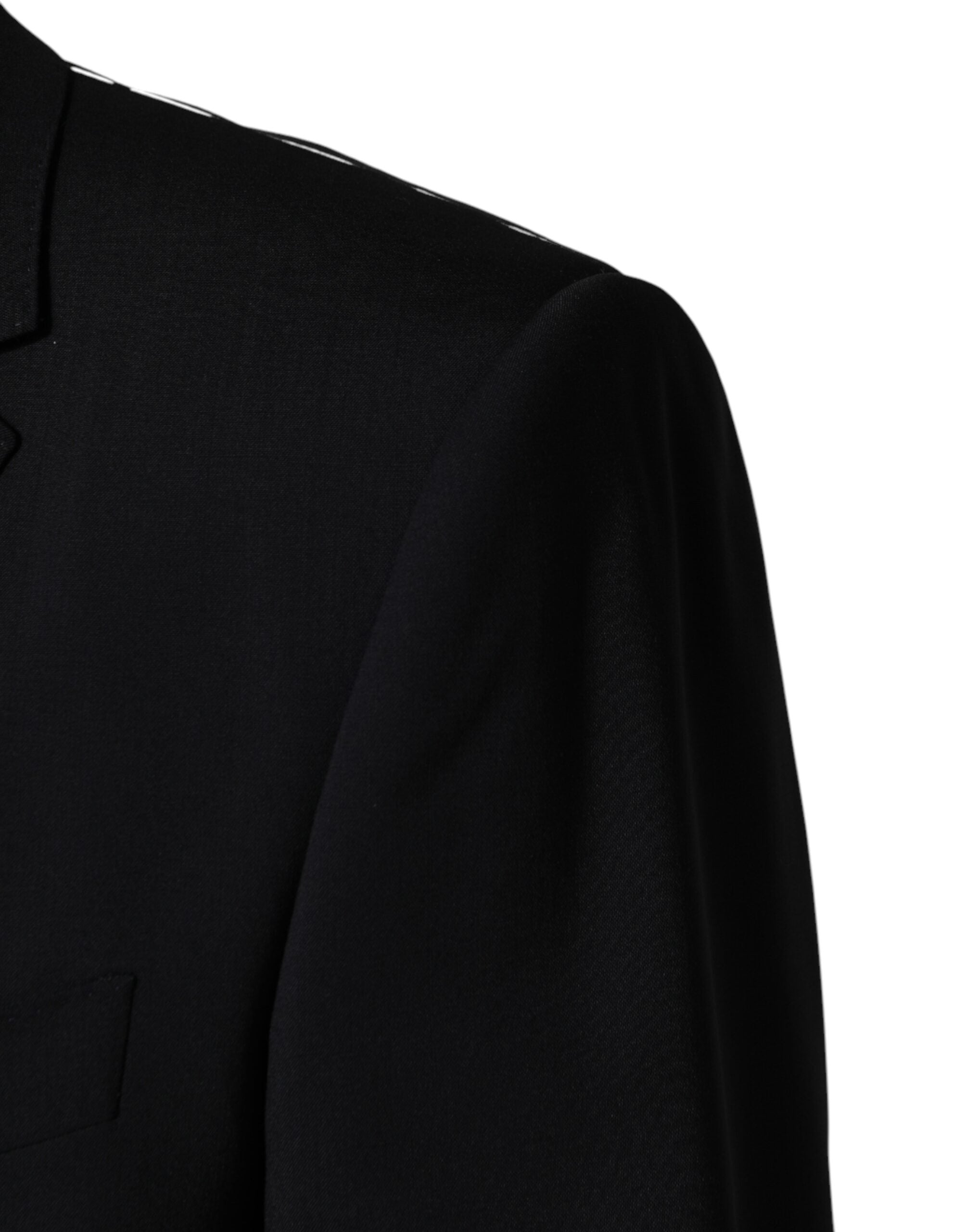 Experience the allure of the Dolce & Gabbana Black Wool Single Breasted Blazer, crafted in Italy from premium virgin wool, embodying timeless sophistication and exquisite craftsmanship for the discerning individual.
