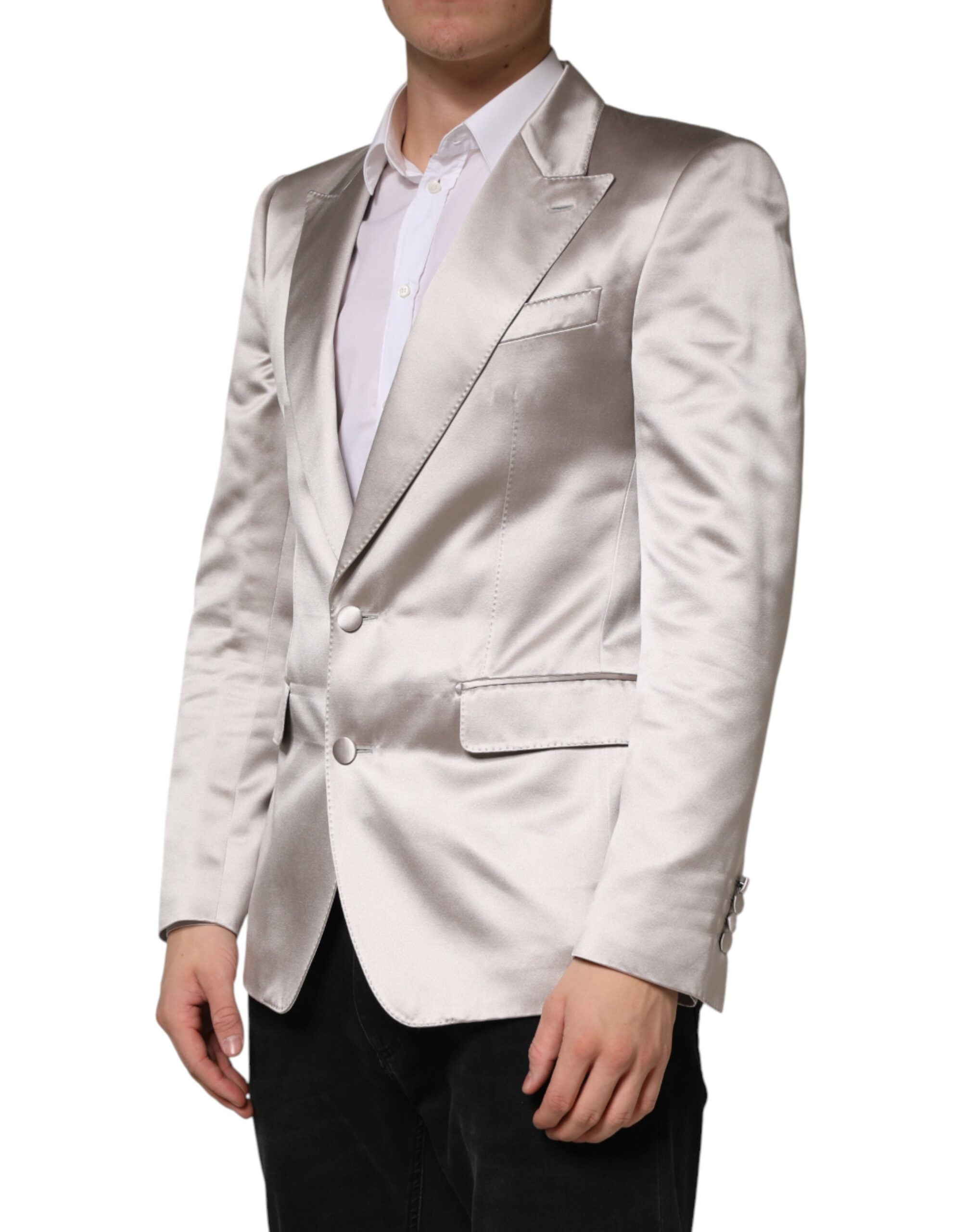 Indulge in the exquisite Dolce & Gabbana Silver SICILIA Blazer, a masterpiece of silk craftsmanship that embodies timeless elegance and sophisticated allure for discerning individuals.