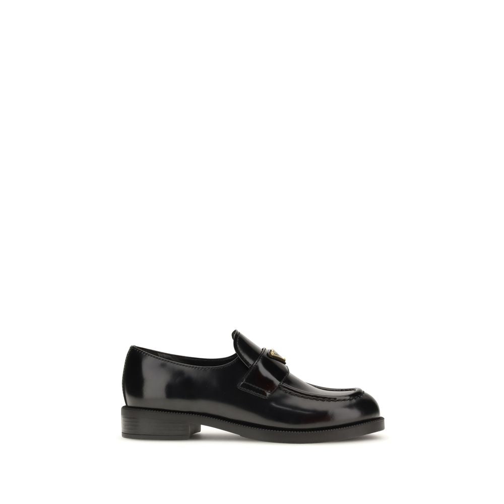 Experience the allure of Prada Black Calf Leather Bos Taurus Slip-On Loafers, where exquisite craftsmanship meets timeless elegance for the discerning individual.