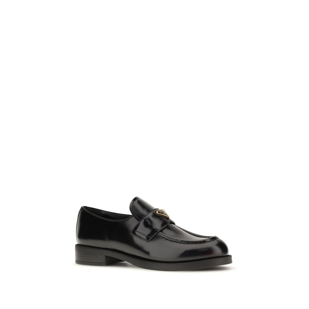 Experience the exquisite allure of Prada Black Calf Leather Bos Taurus Slip-On Loafers, where artisanal craftsmanship meets timeless elegance for the discerning individual.