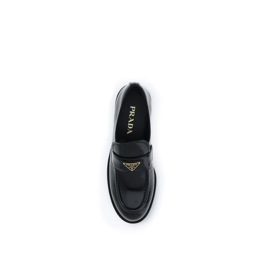 Experience the exquisite craftsmanship of Prada Black Calf Leather Bos Taurus Slip-On Loafers, where timeless elegance meets luxurious comfort for the discerning individual.