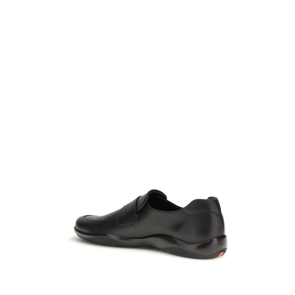 Elevate your elegance with Prada's Black Calf Leather Bos Taurus Slip-On Loafers, where exquisite craftsmanship meets contemporary luxury for the discerning individual.