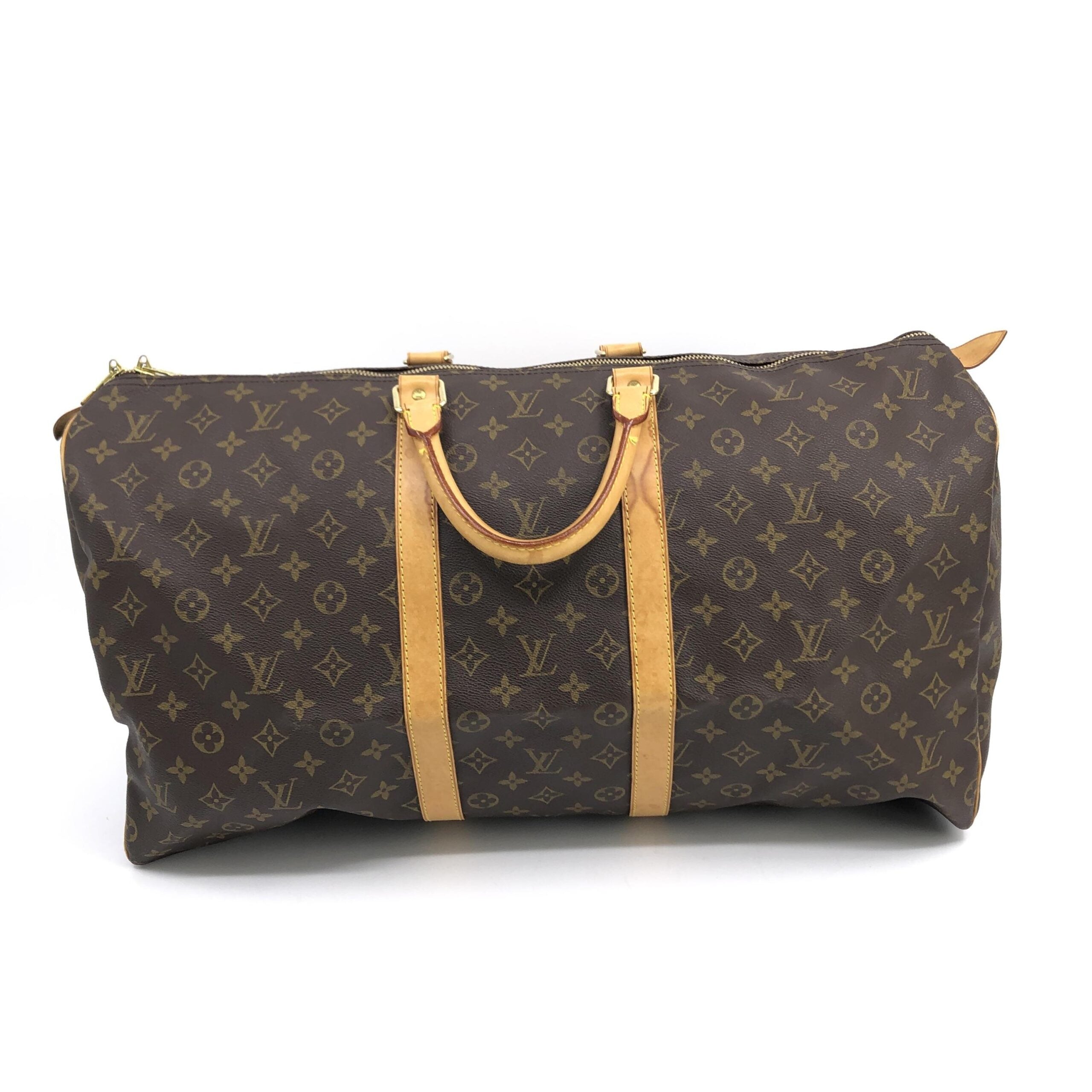Experience the timeless elegance of the Louis Vuitton Monogram Keepall 55 Handbag, a masterpiece of exquisite craftsmanship and iconic design, perfect for discerning travelers.