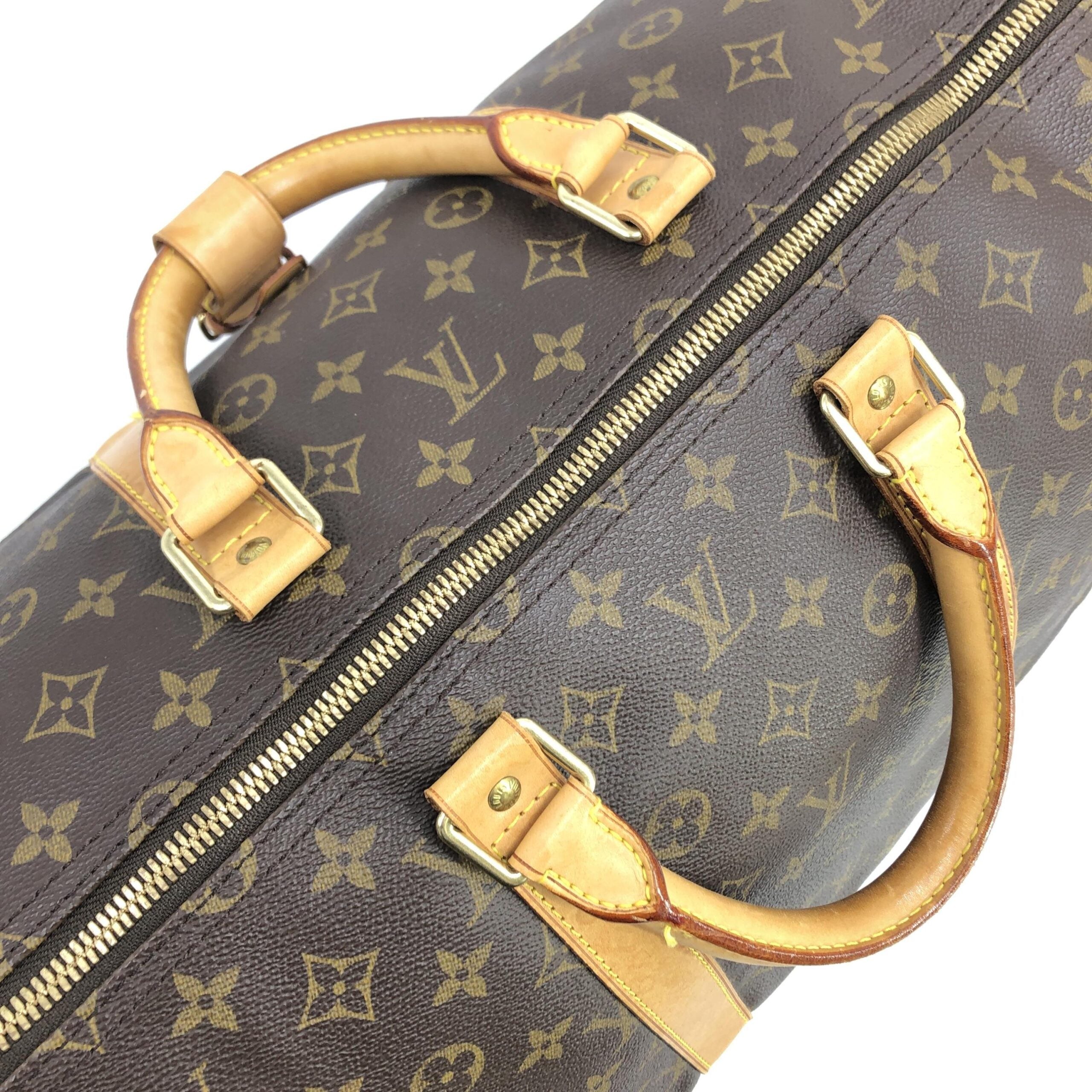 Discover the Louis Vuitton Monogram Keepall 55 Handbag, a timeless travel companion crafted from signature monogram canvas, embodying luxury and sophistication for discerning individuals.