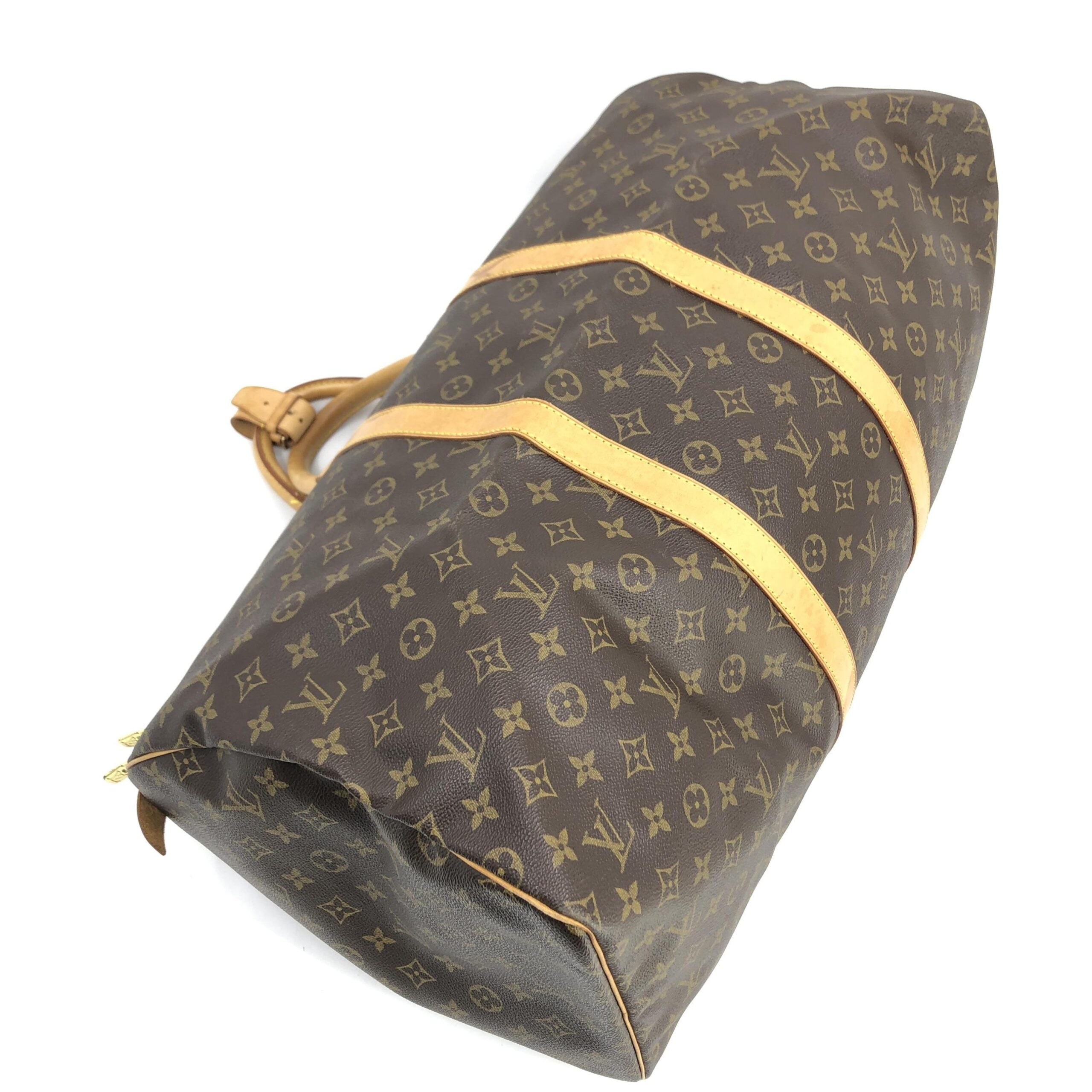 Discover the Louis Vuitton Monogram Keepall 55 Handbag, a timeless masterpiece of signature canvas, expertly crafted for those who embody elegance and sophistication.