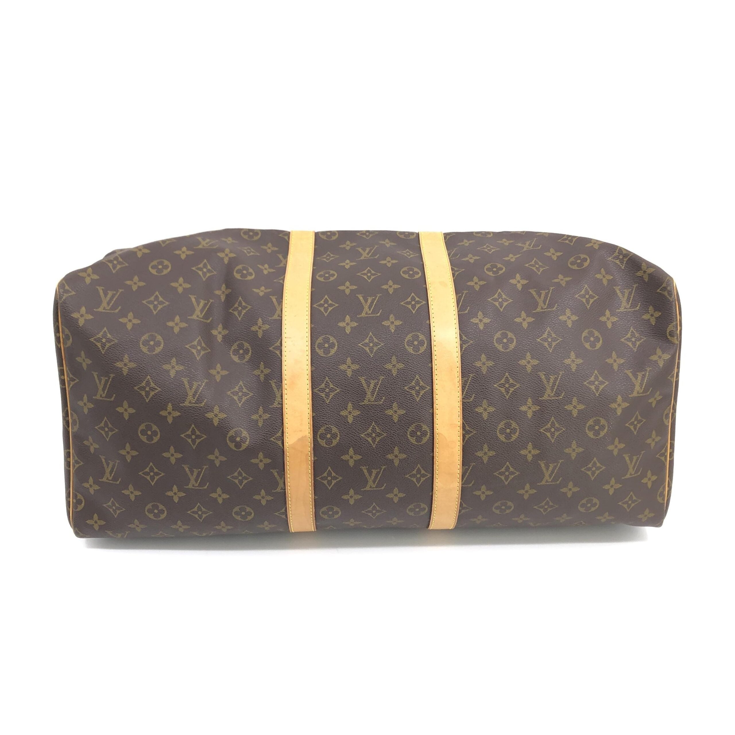 Indulge in the timeless elegance of the Louis Vuitton Monogram Keepall 55 Handbag, a masterpiece of signature canvas, perfect for discerning travelers seeking luxury and sophistication.