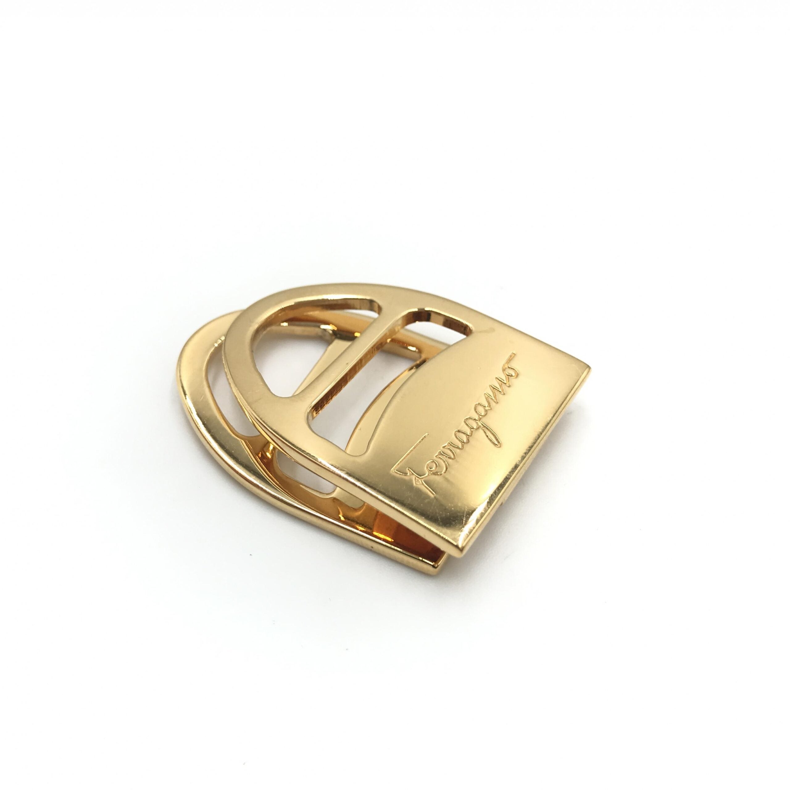 Elevate your style with the Salvatore Ferragamo Vara Metal Scarf Ring, a timeless piece of luxurious craftsmanship that transforms any ensemble into a statement of elegance.
