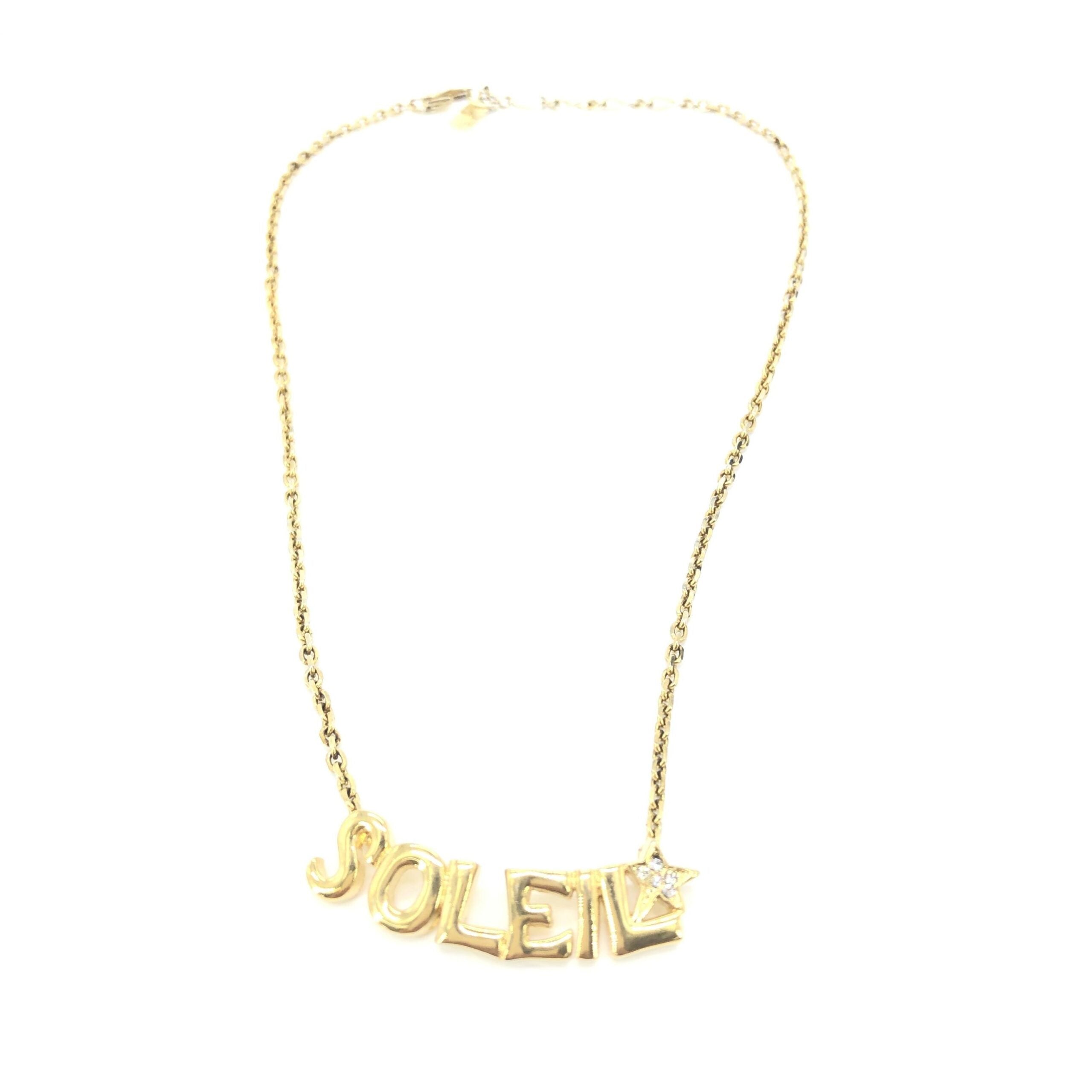 Discover the Yves Saint Laurent Soleil Designer Statement Necklace, a luxurious gold-tone masterpiece adorned with radiant rhinestones, perfect for elevating any ensemble with timeless elegance.