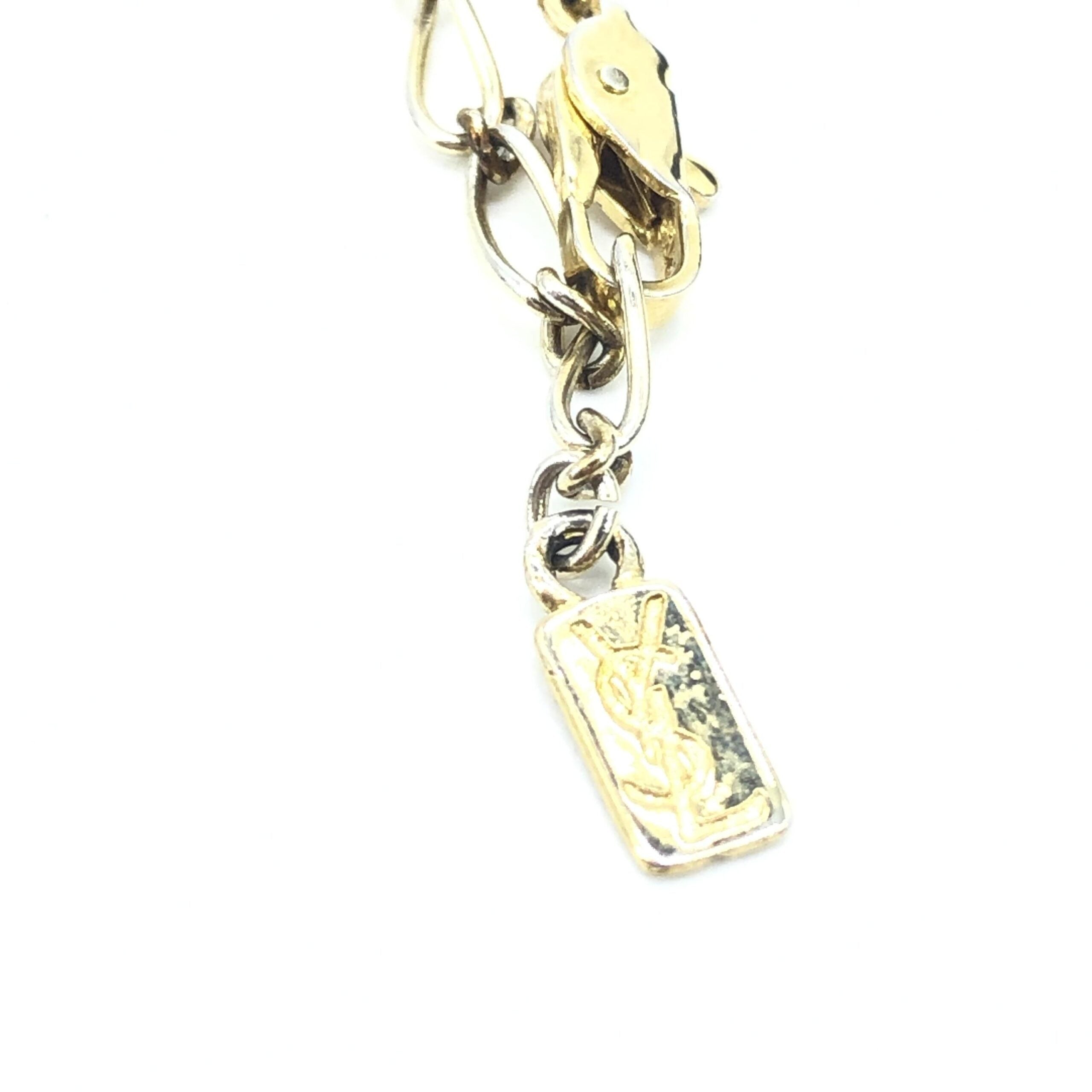 Elevate your elegance with the Yves Saint Laurent Soleil Designer Statement Necklace, a masterpiece of gold-tone metal and rhinestones, embodying timeless luxury and sophistication.
