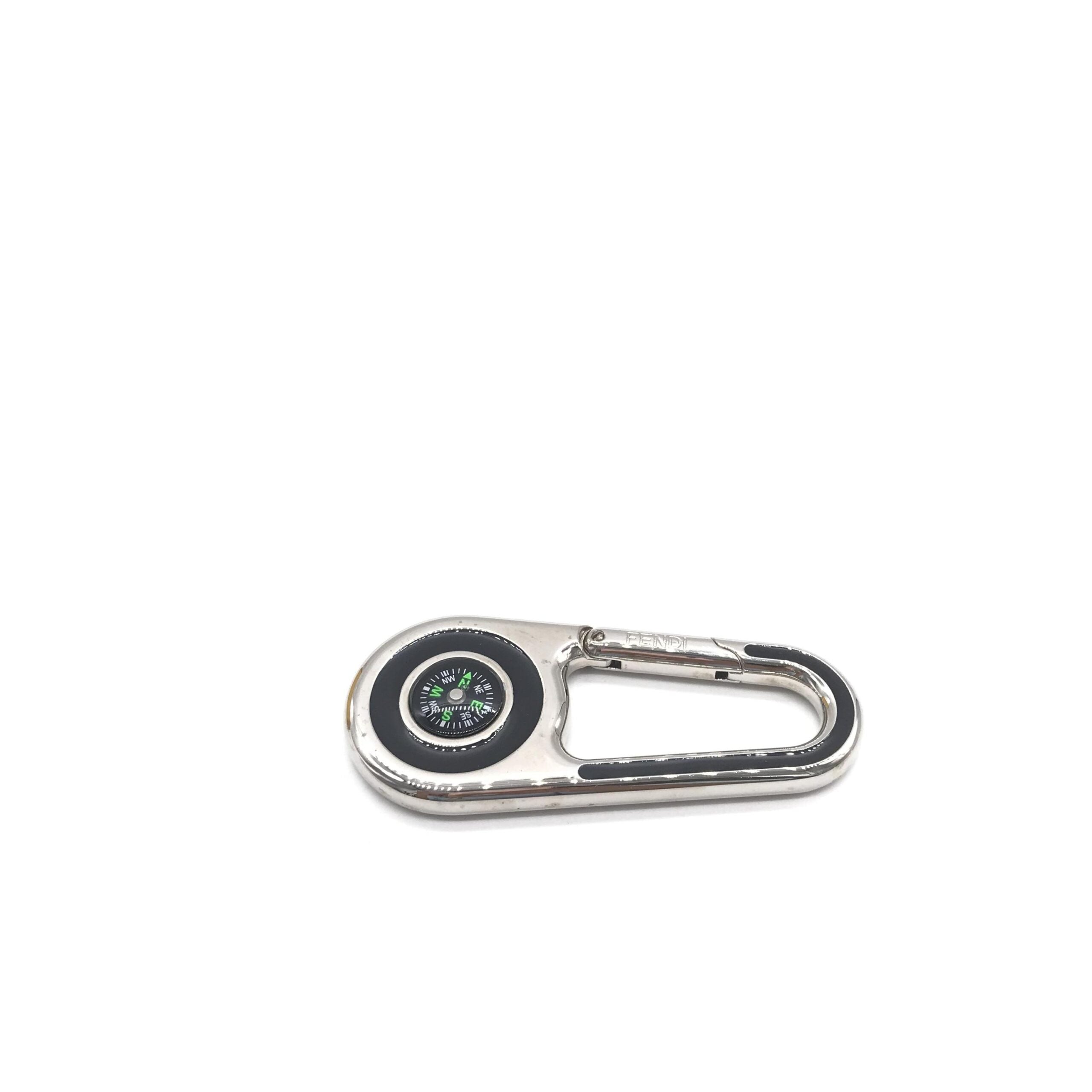 Experience the allure of the Fendi Silver Metal Compass Charm Keychain, a symbol of exquisite craftsmanship and timeless elegance, perfect for life's sophisticated journeys.