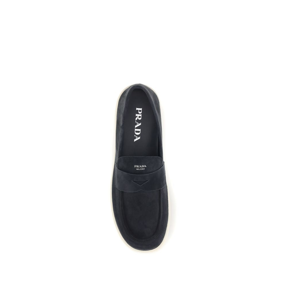 Indulge in the timeless elegance of Prada Blue Calf Leather Bos Taurus Slip-On Loafers, where exquisite craftsmanship meets luxurious comfort for the discerning individual.