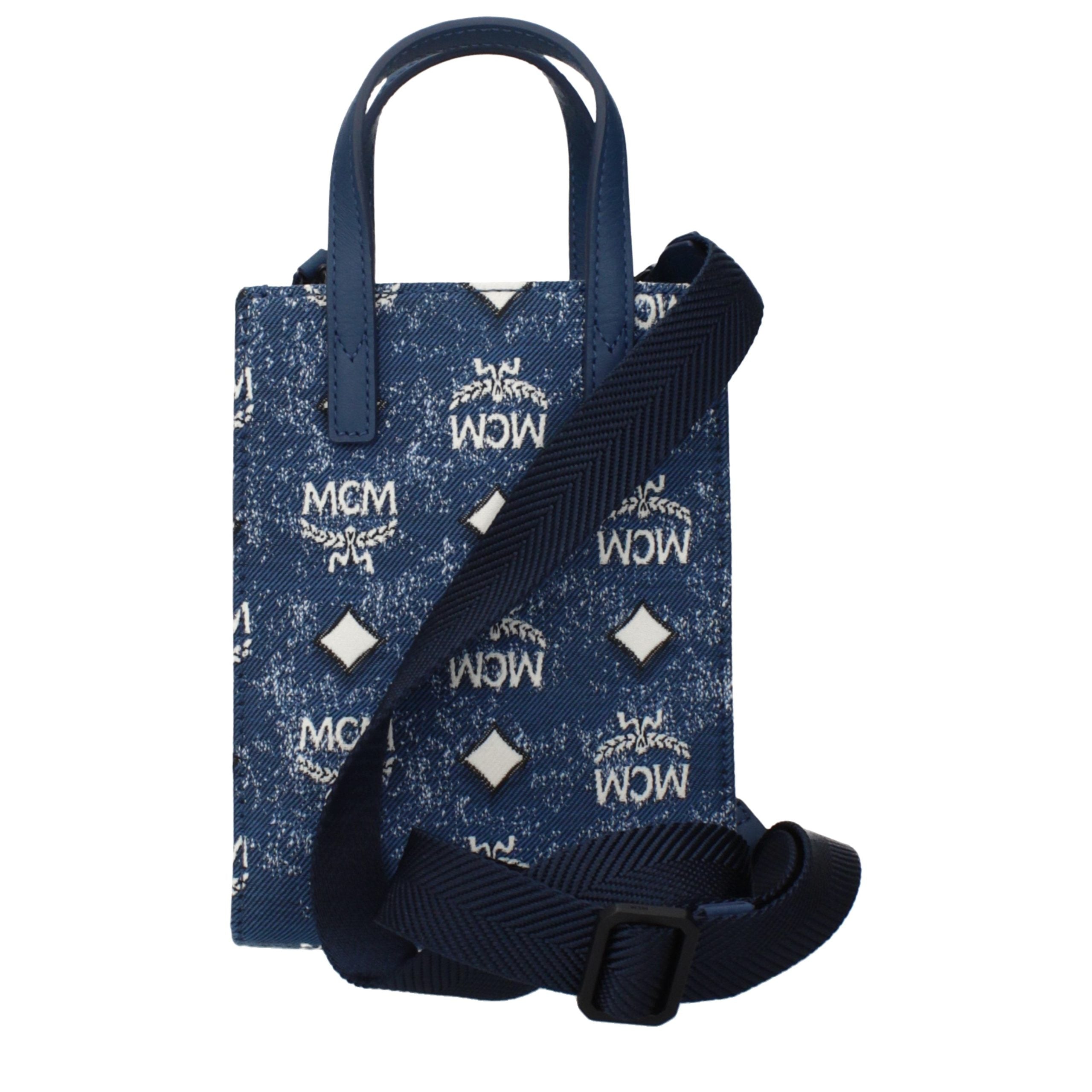 Elevate your elegance with the MCM Blue Fabric Handbag, a luxurious statement piece that embodies sophistication and versatility for the discerning individual.