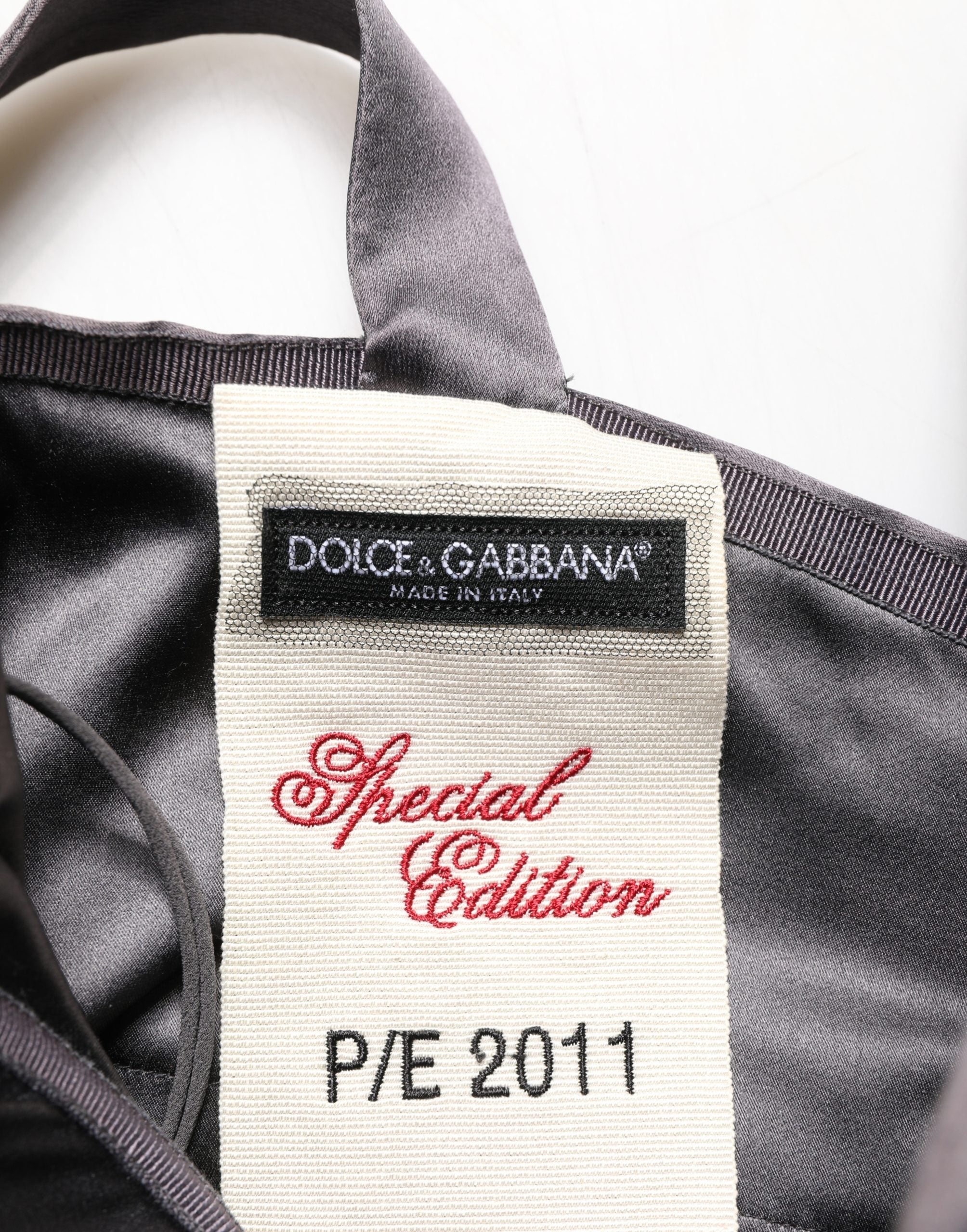 Indulge in the exquisite Dolce & Gabbana Black Satin Sleeveless Sweetheart Dress, a timeless blend of silk and elegance, embodying Italian luxury and sophistication.